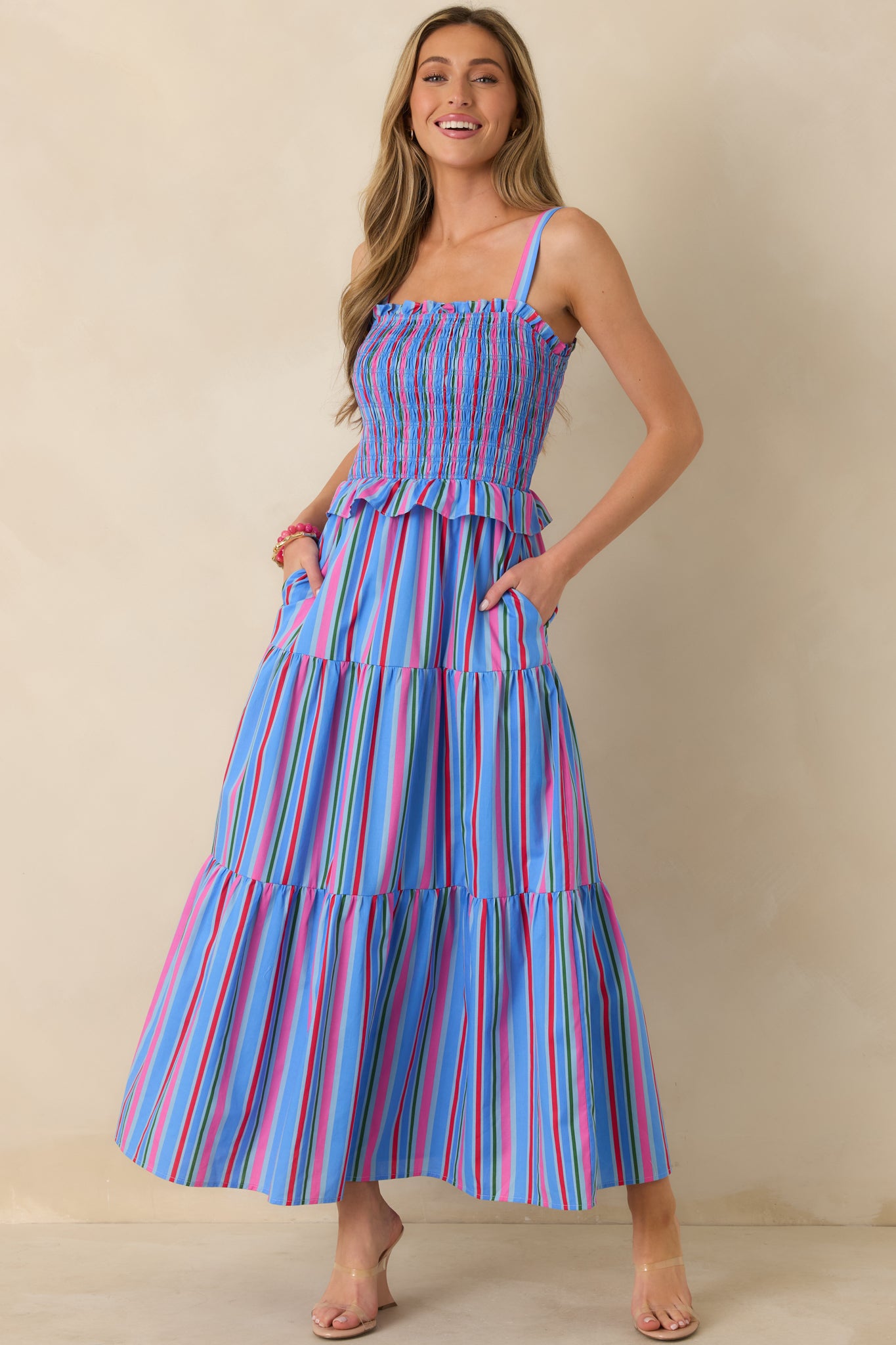 Multicolor blue dress with flexible smocked bodice and tiered skirt for gentle movement.