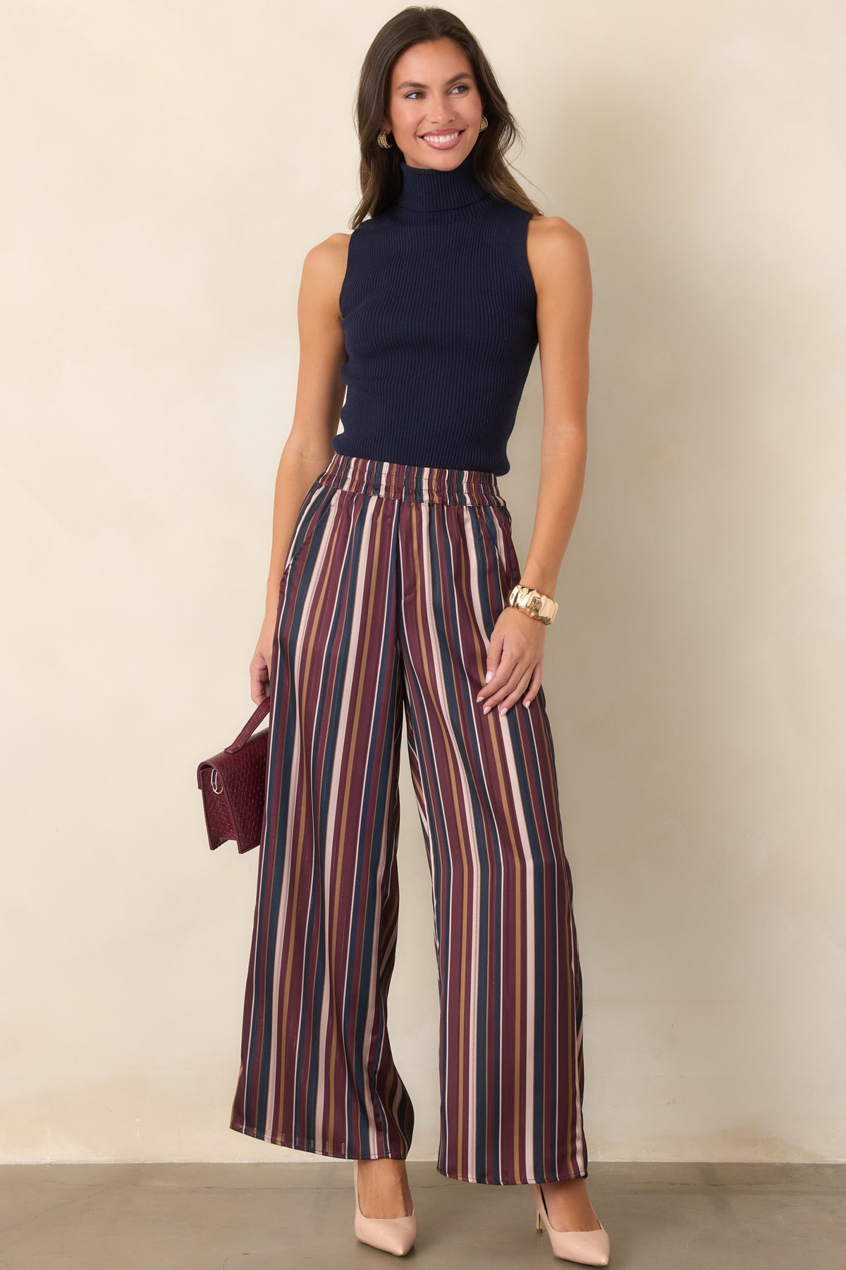 Multicolor satin pants showcasing rich vintage-inspired stripes in burgundy, navy, champagne, and olive.