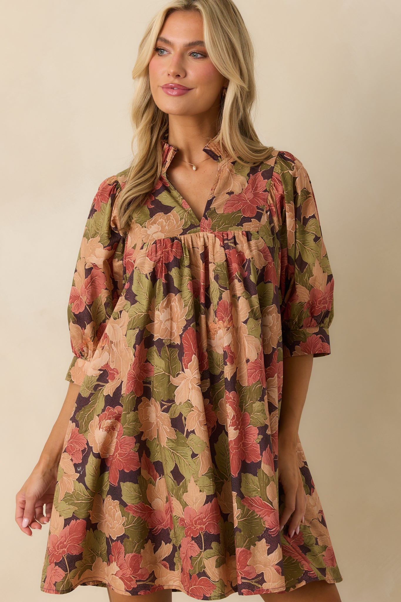 Half-length puff sleeve with button cuff detail in the multicolor floral print.