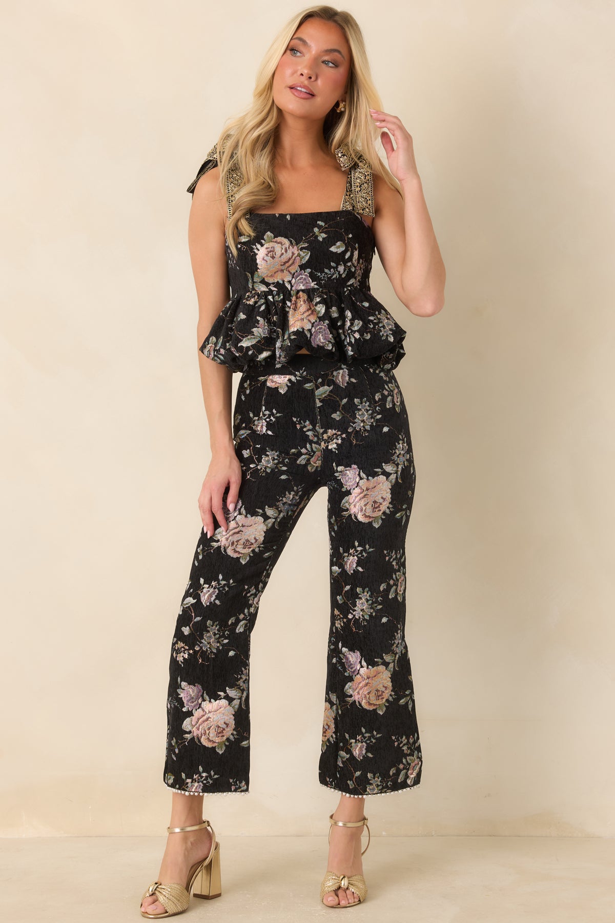 Multicolor floral cropped top featuring a straight neckline, decorative shoulder ties, and a voluminous hem.