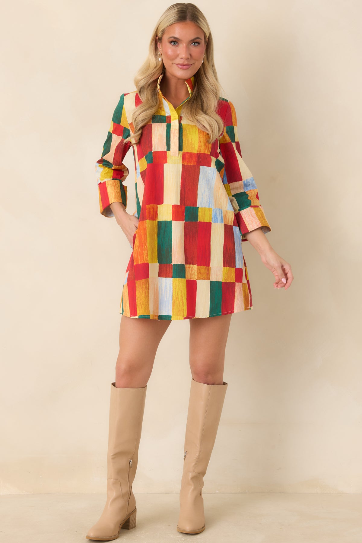 Multicolor geometric print mini dress featuring a standing collar, partial button placket, three-quarter sleeves, and relaxed silhouette.