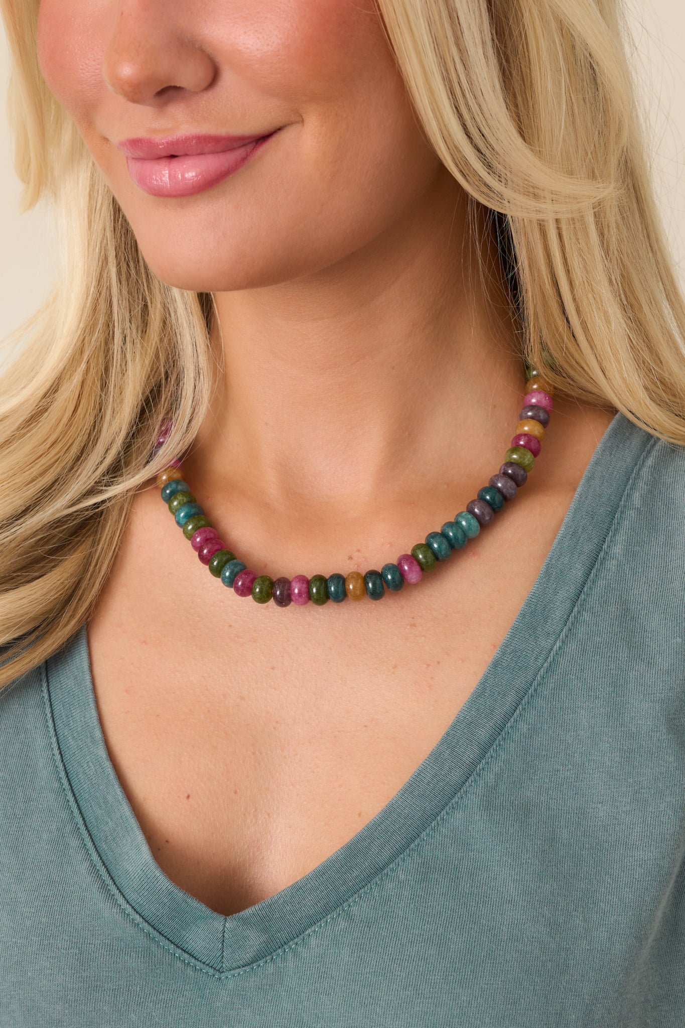 Multicolor necklace featuring smooth disc beads in teal, olive, berry, plum, pink, and golden mustard tones.