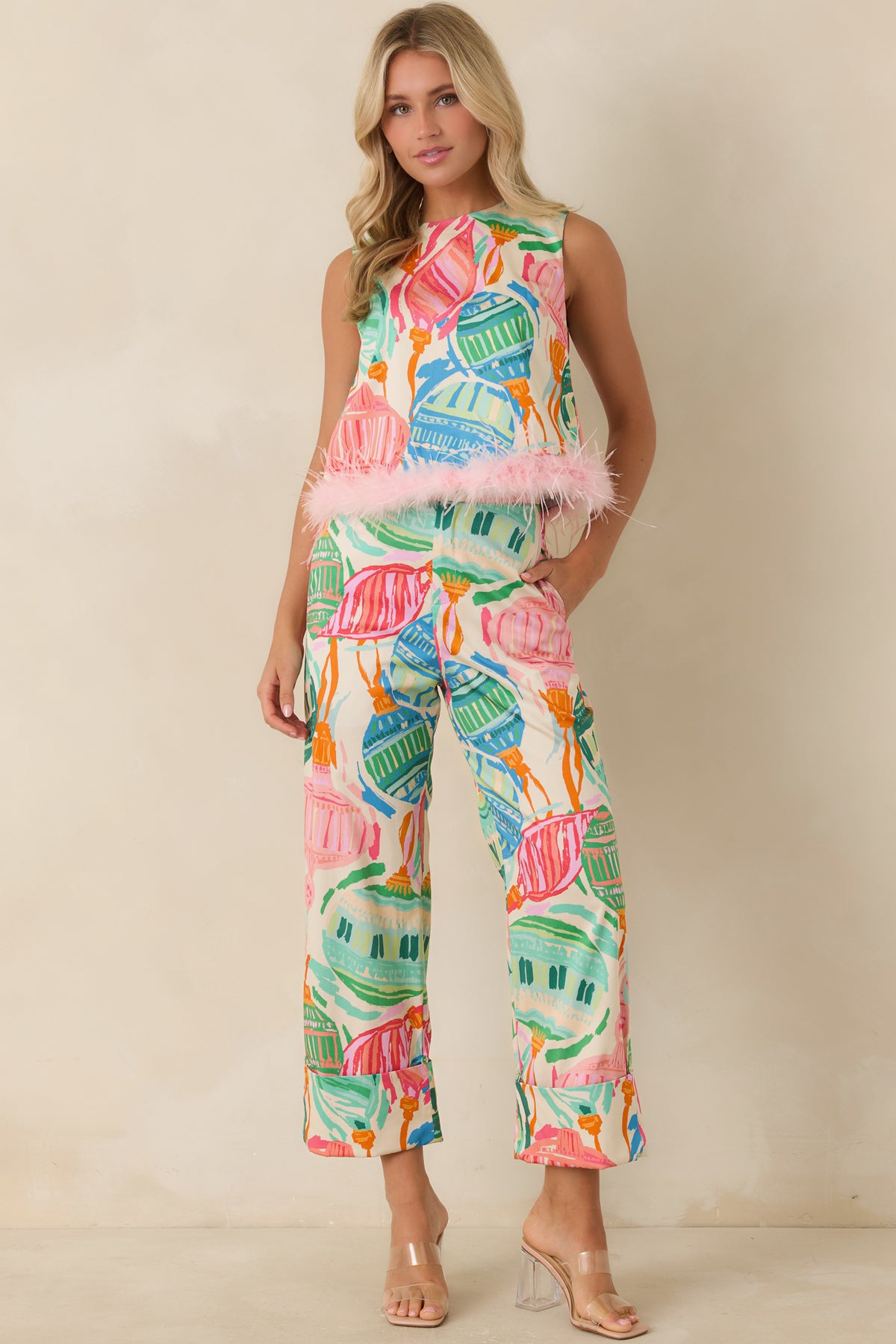 Printed cotton pants with wide legs, cuffed hems, and vibrant multicolored ornaments.
