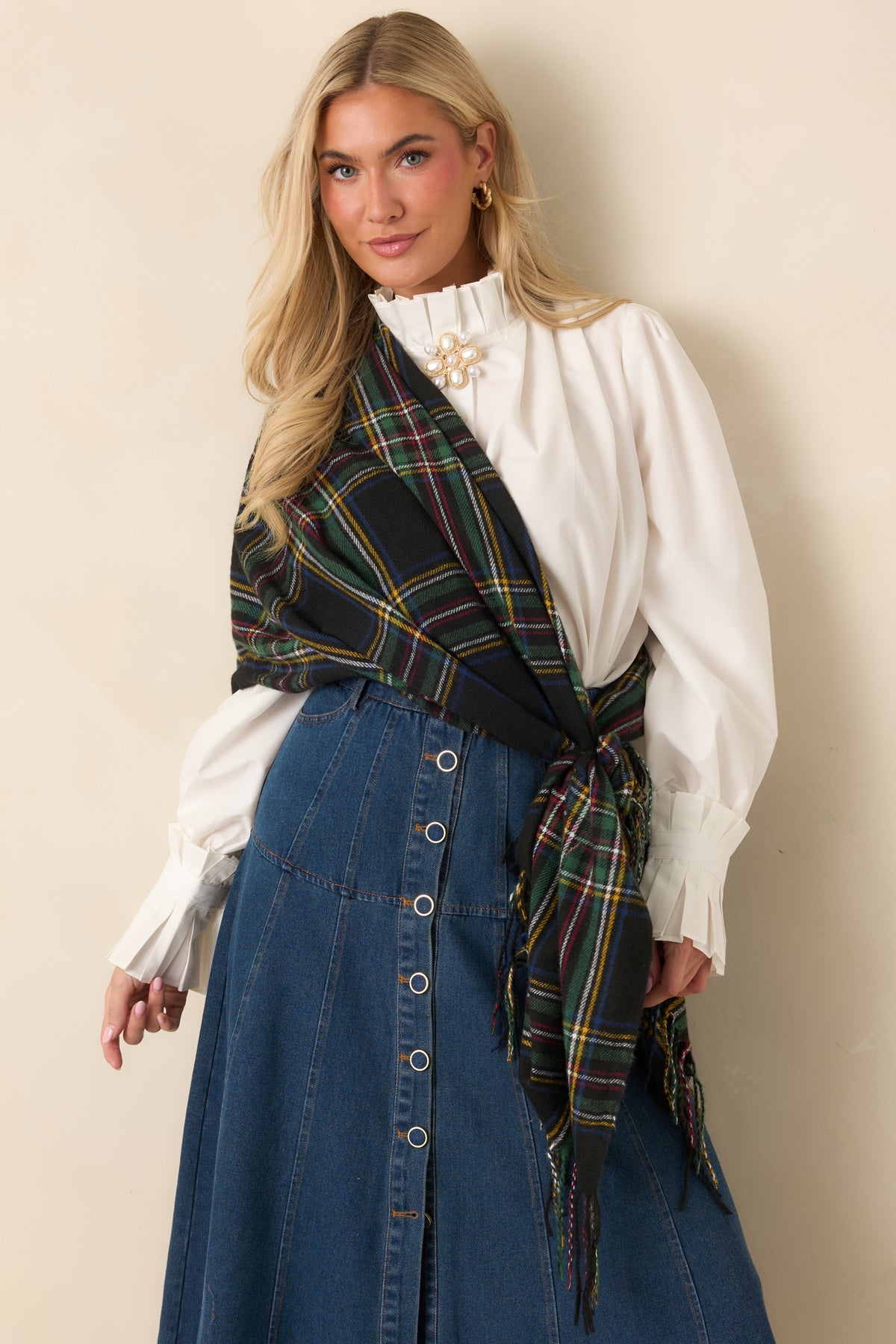 Multicolor plaid scarf with blue and ivory lines crossing a black background and rich green stripes.