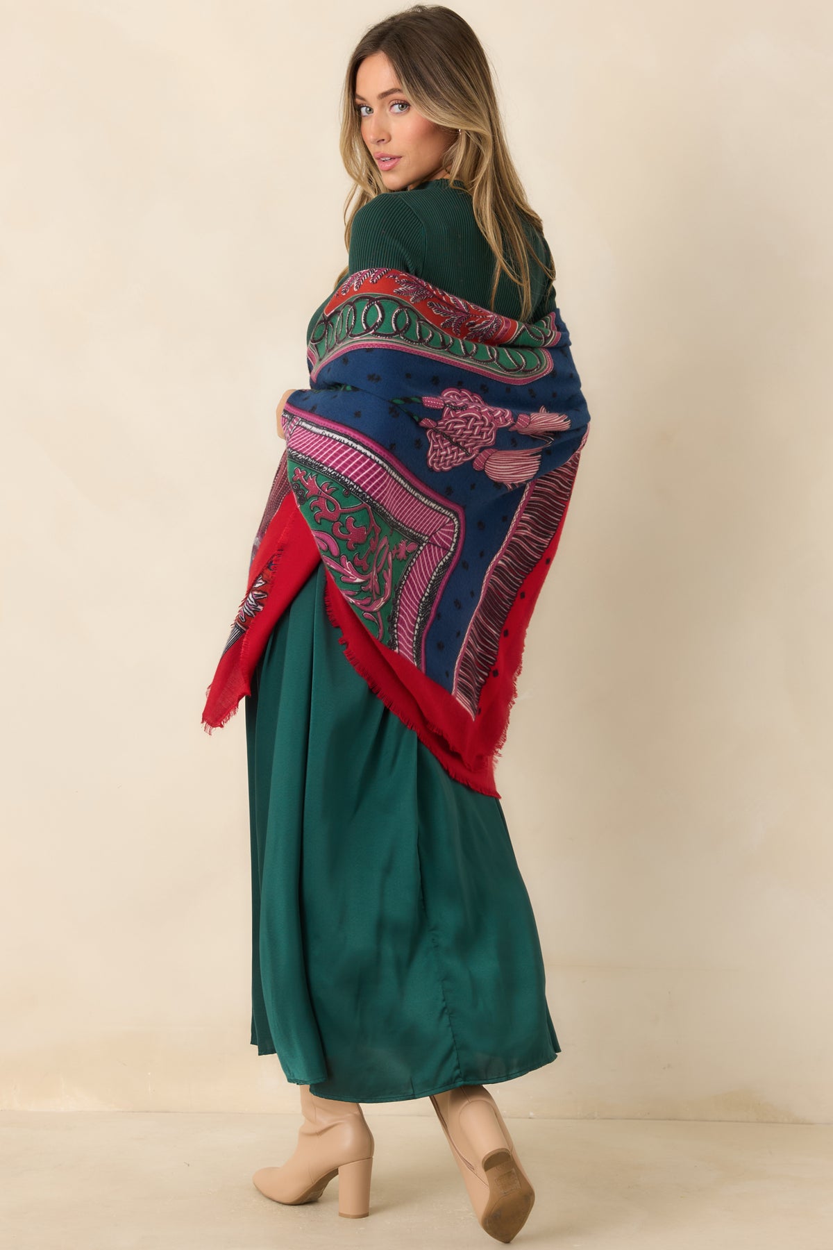 Intricate multicolor pattern with scrolling borders, a bold red edge, and fine fringe trim.