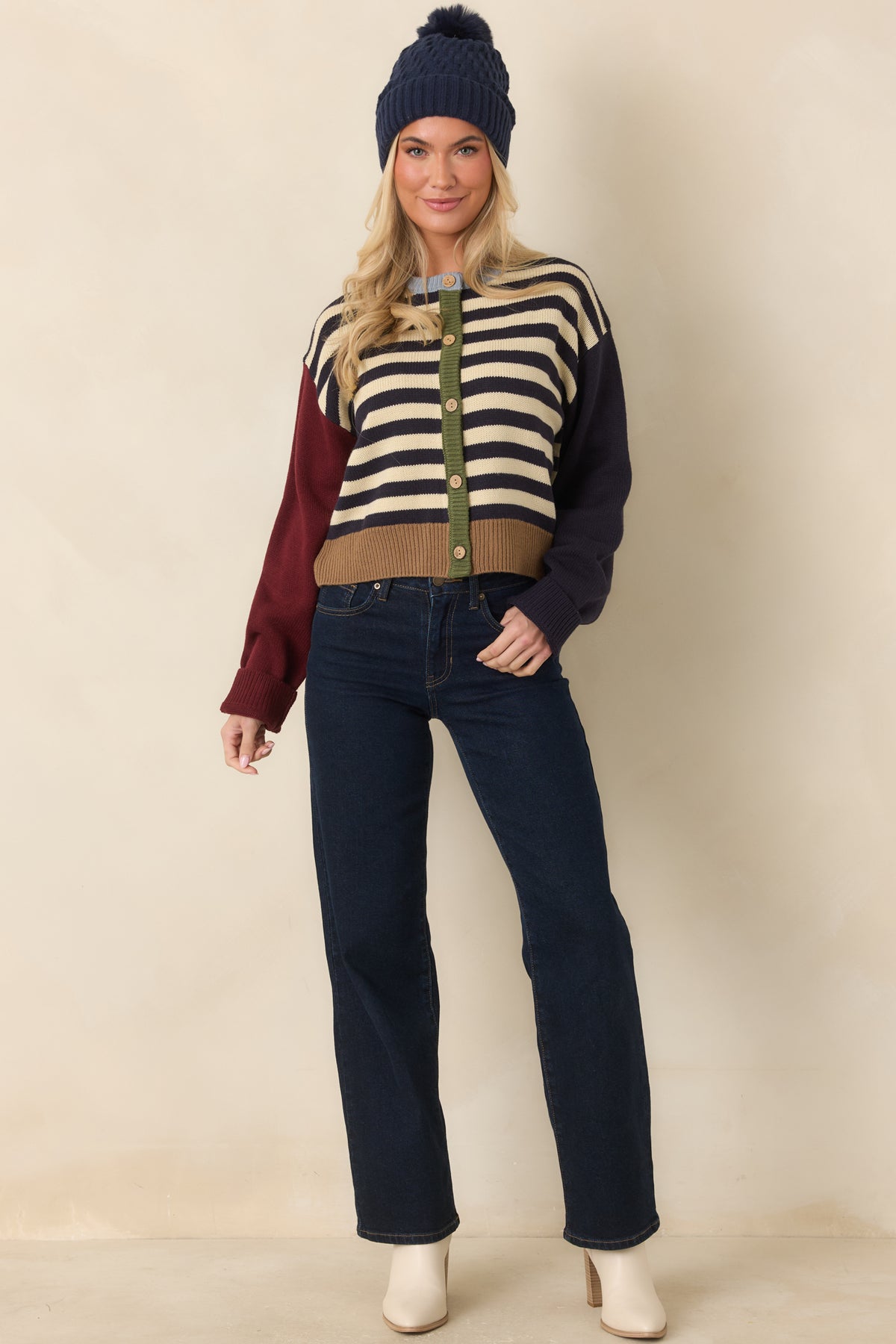 Multicolor knit cardigan with burgundy and navy sleeves, a light blue neckline, and a camel ribbed bottom hem.