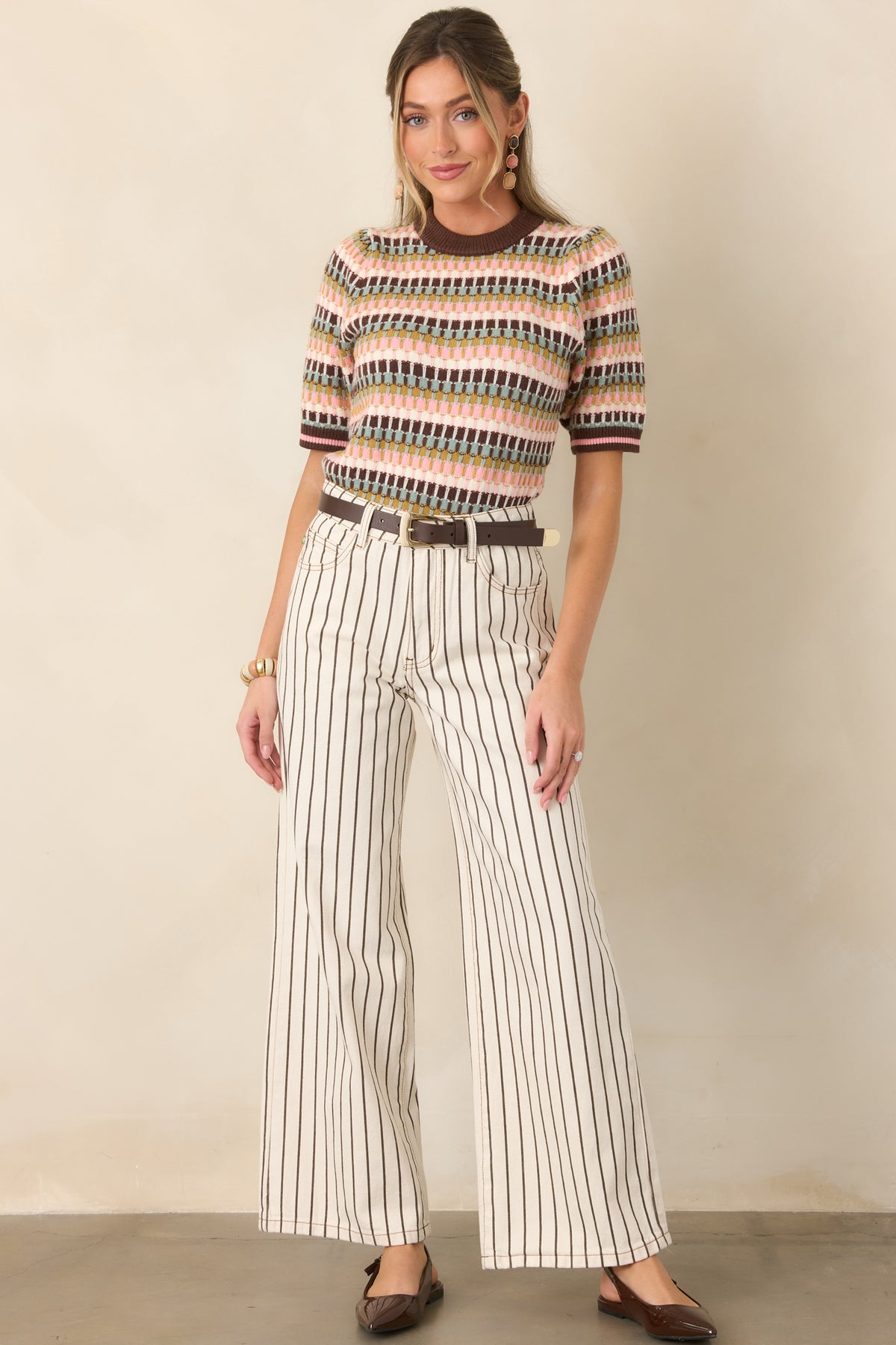 Soft knit top displaying dimensional multicolor stripes in brown, sage, olive, blush pink, and ivory with contrasting chocolate brown edging.