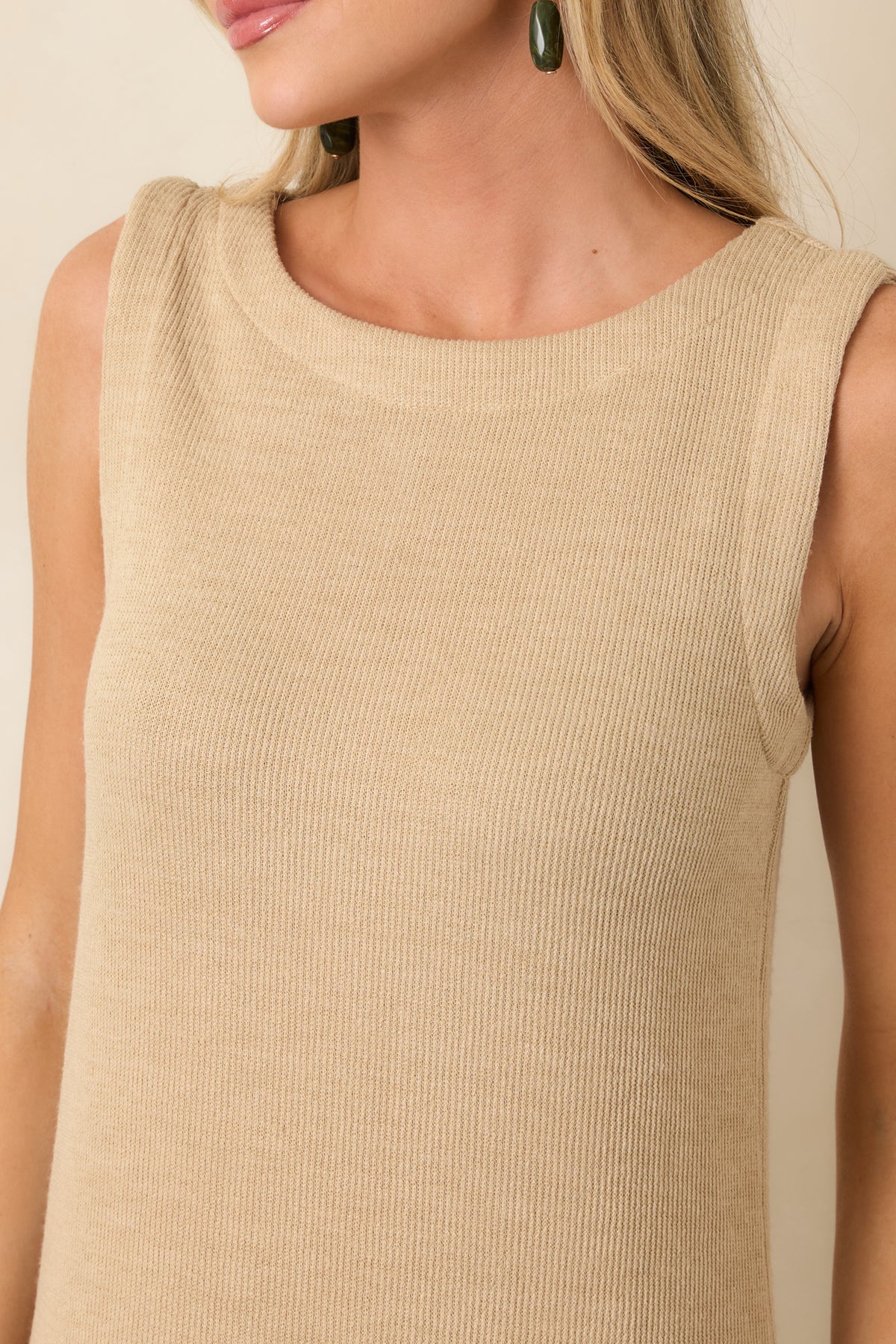 Close detail of the natural rib knit fabric highlighting its soft texture and rounded neckline.