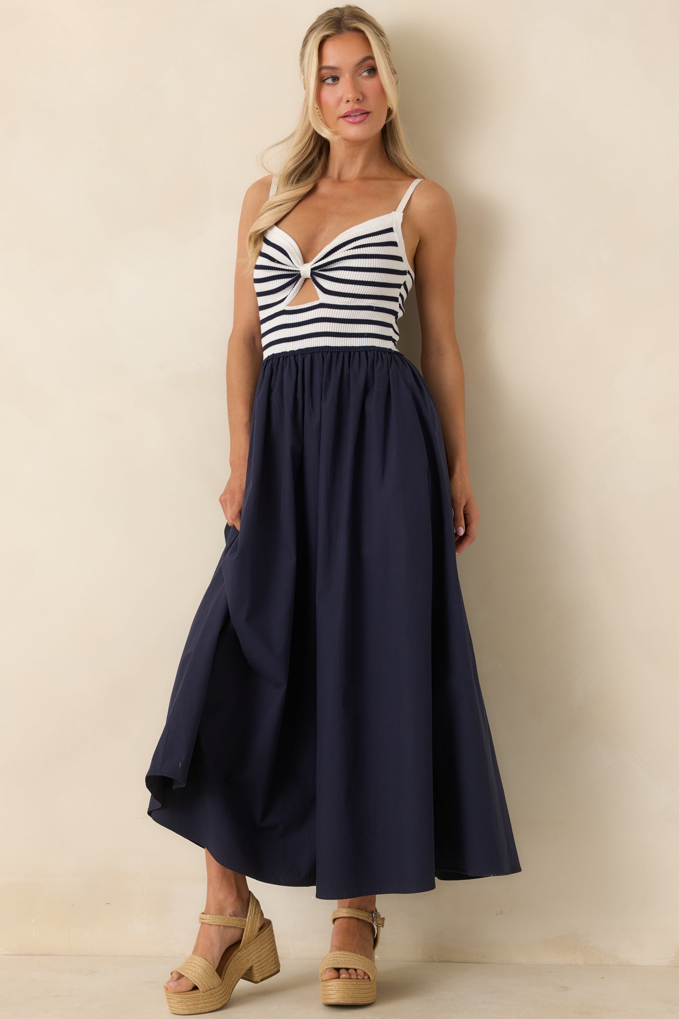 Navy and ivory dress with structured stretch bodice and lightweight flowing skirt.