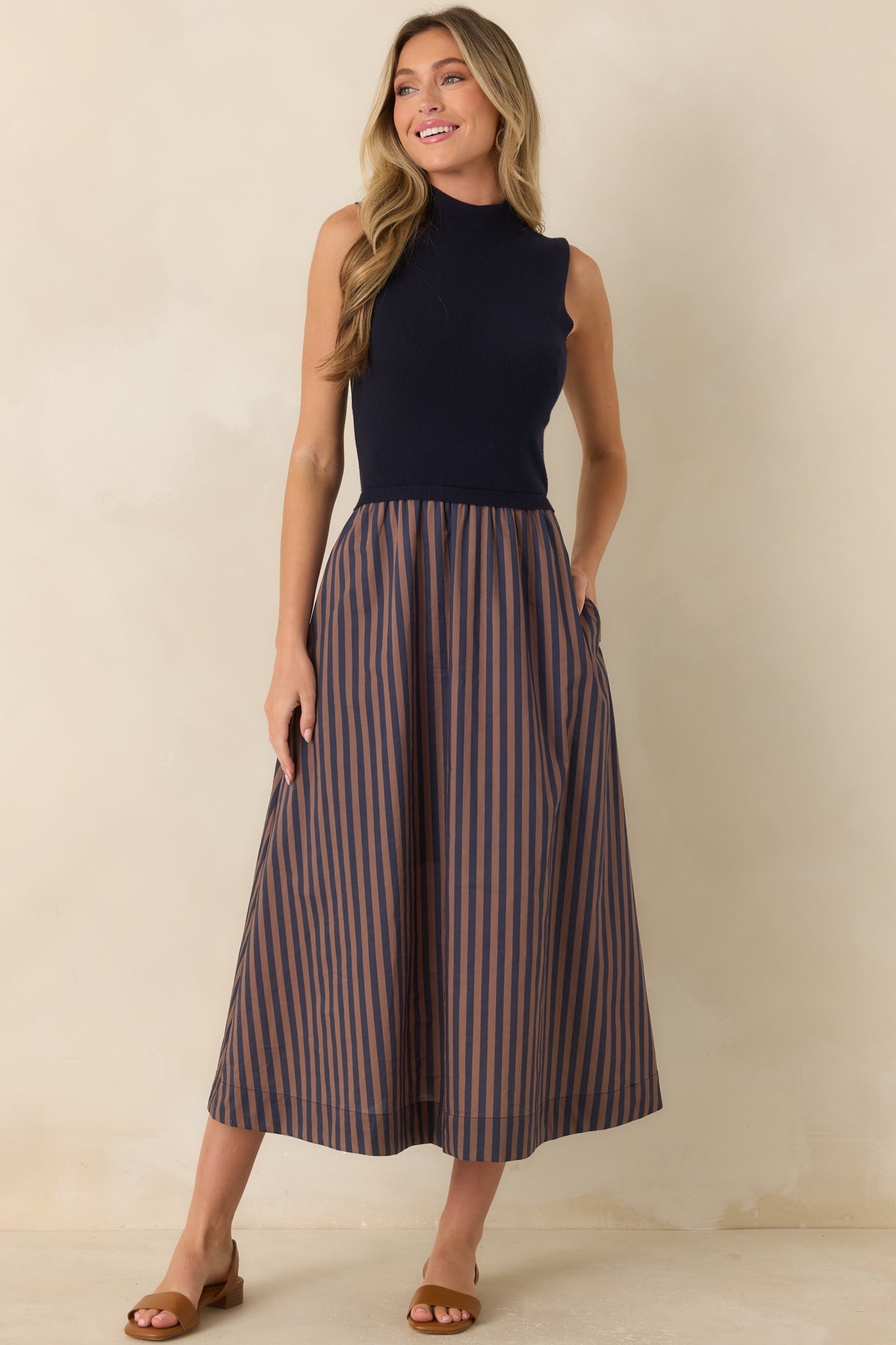 Navy and tan midi dress showcasing a timeless color combination, elegant proportions, and graceful skirt movement.