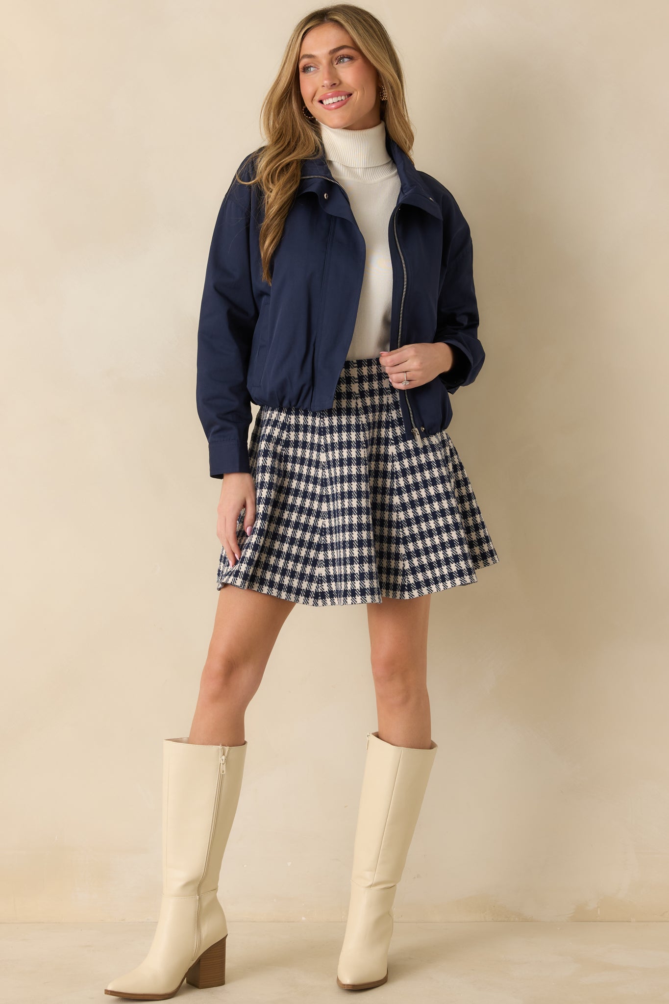 Front view of navy blue gingham knit mini skirt showing high-waisted fit and flared silhouette.