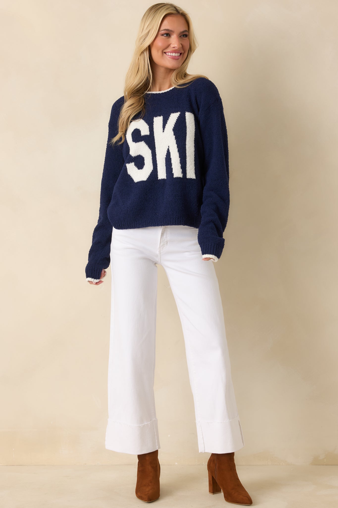 Navy blue knit sweater featuring the front “SKI” graphic and ribbed trim accents.