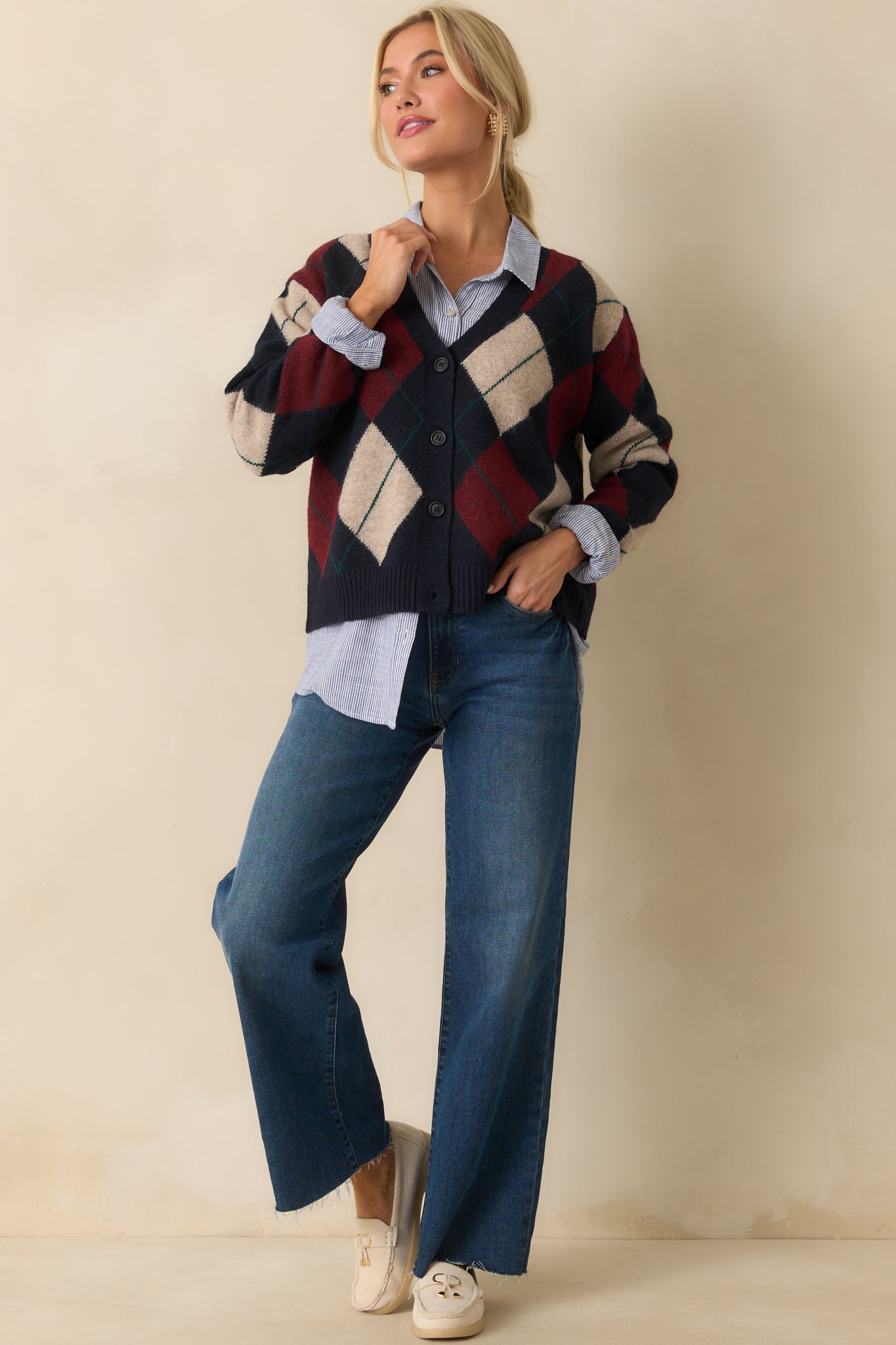 Navy cardigan with burgundy and ivory argyle design, relaxed fit, and long sleeves.