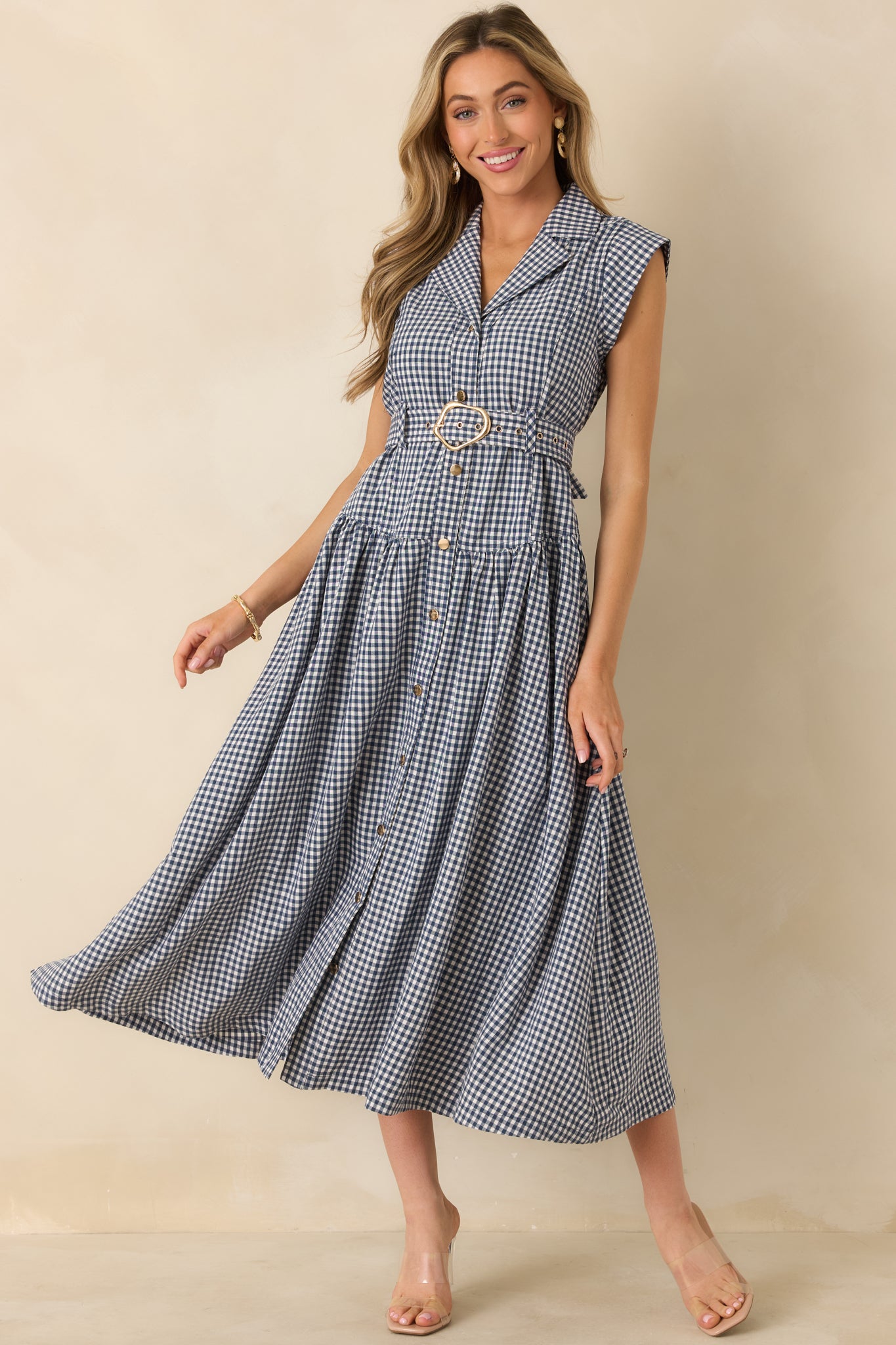 Navy checkered midi dress with a structured collar, button-front detailing, and a flowing midi-length hemline.