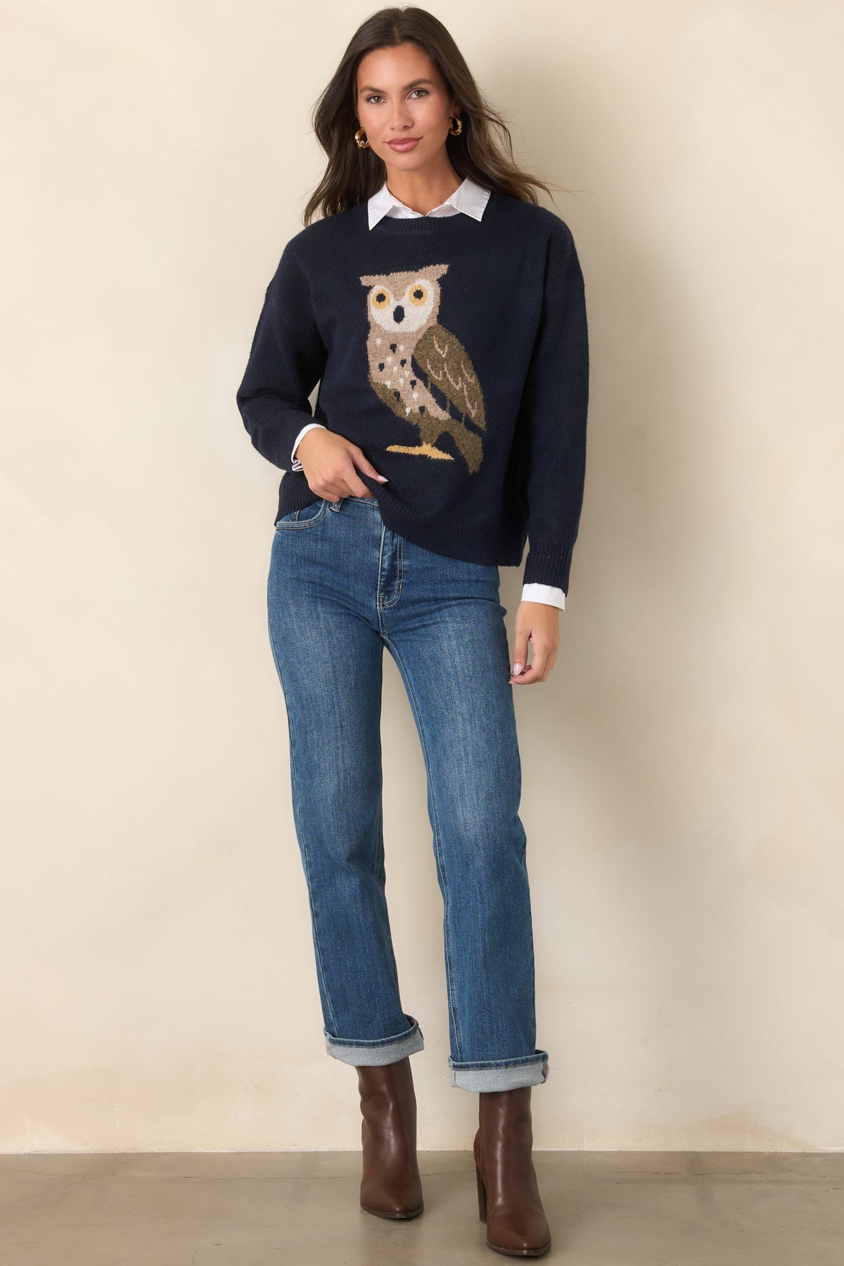 Relaxed navy knit top featuring an ivory and taupe owl with olive and golden yellow accents, framed by a classic crew neckline.