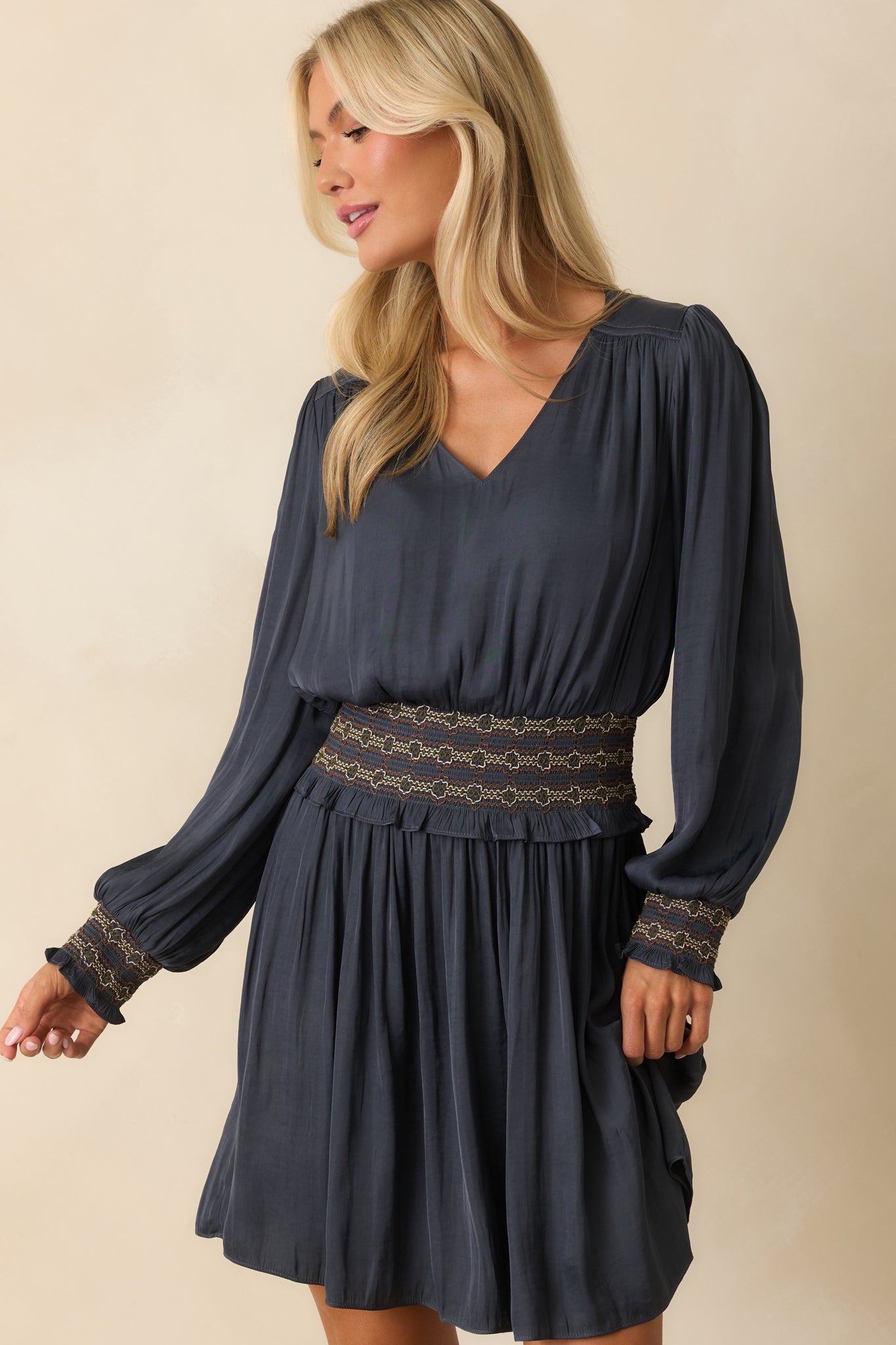 Smocked waistband with multicolor stitching adding contrast to the navy fabric.