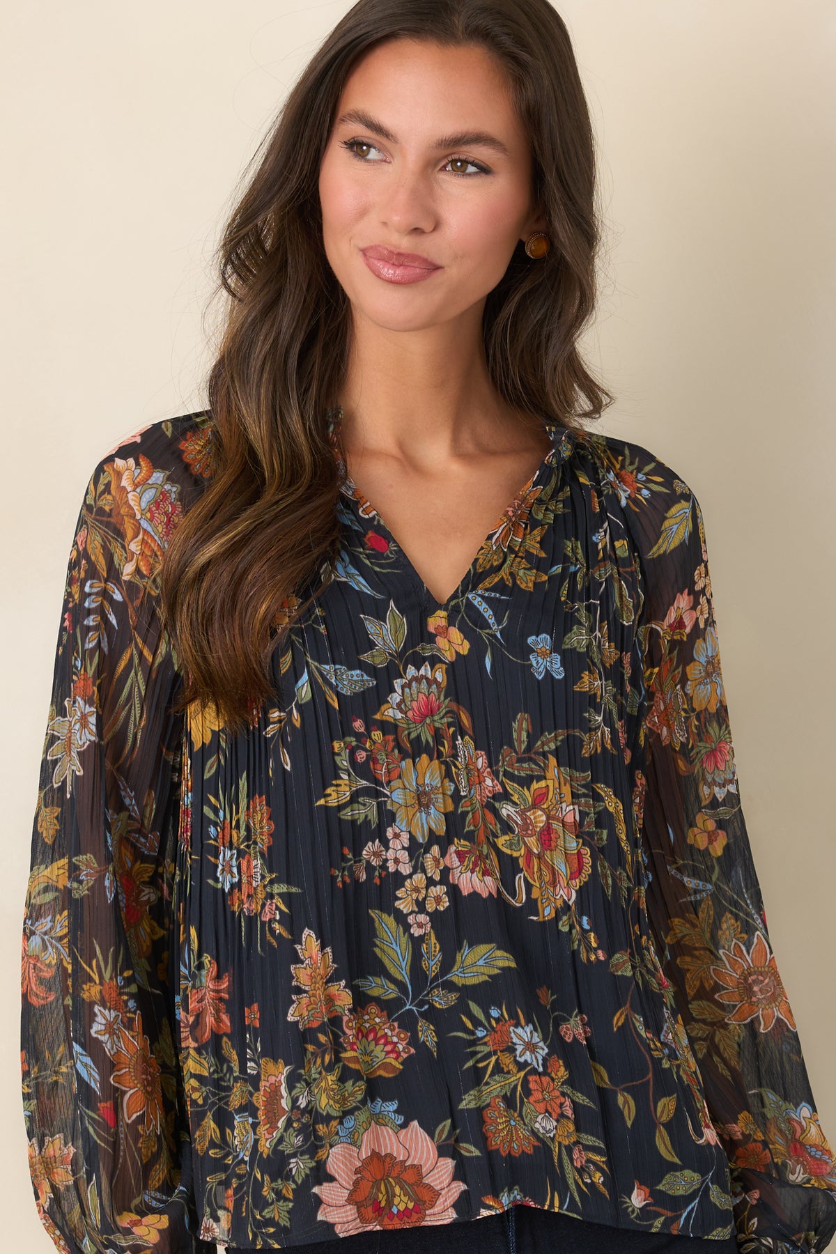 Deep navy top showcasing the fine pleating and colorful botanical print across the bodice.