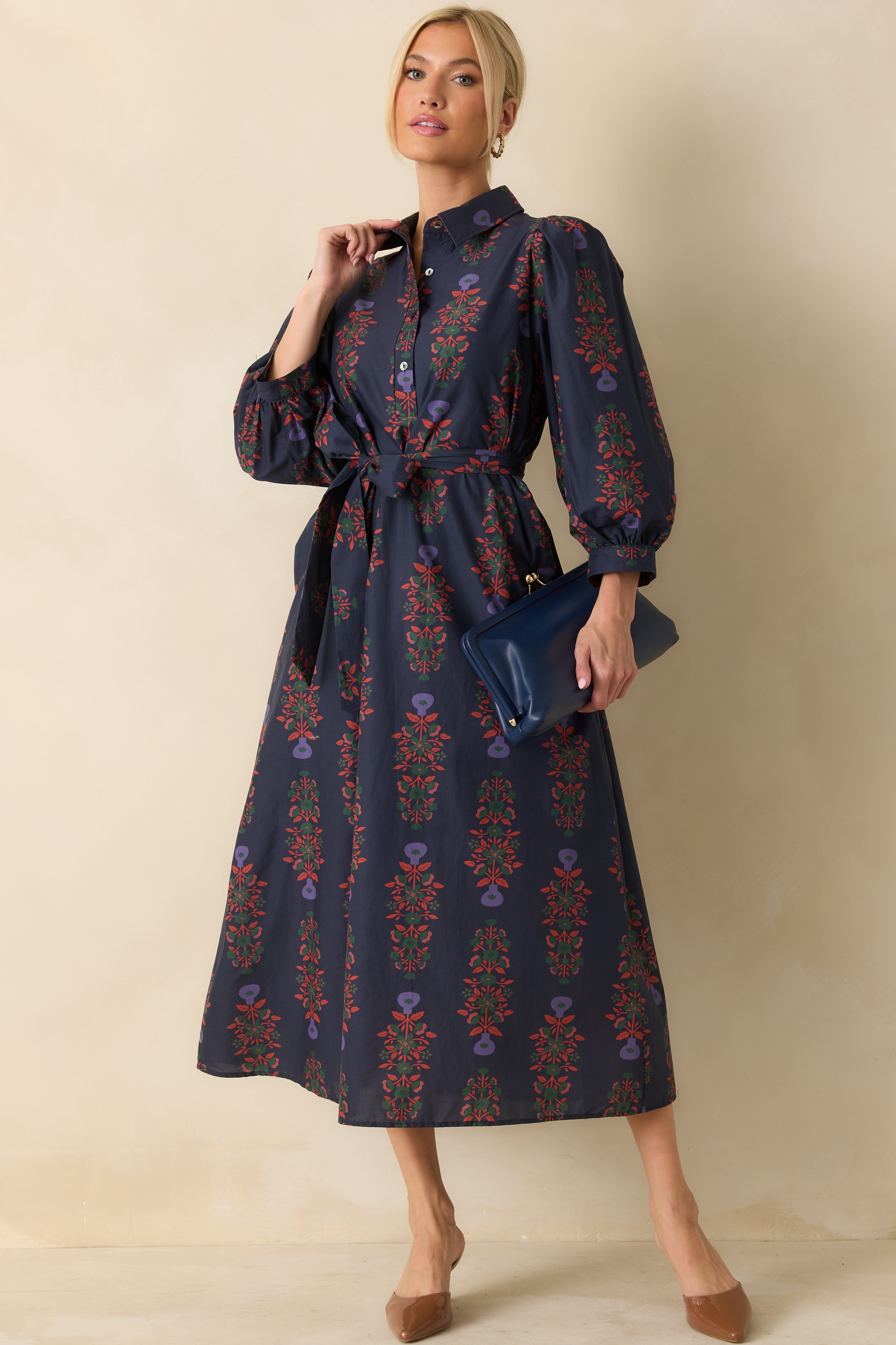 Navy floral cotton maxi dress with button-front closure, self-tie waist, and long puff sleeves with buttoned cuffs.