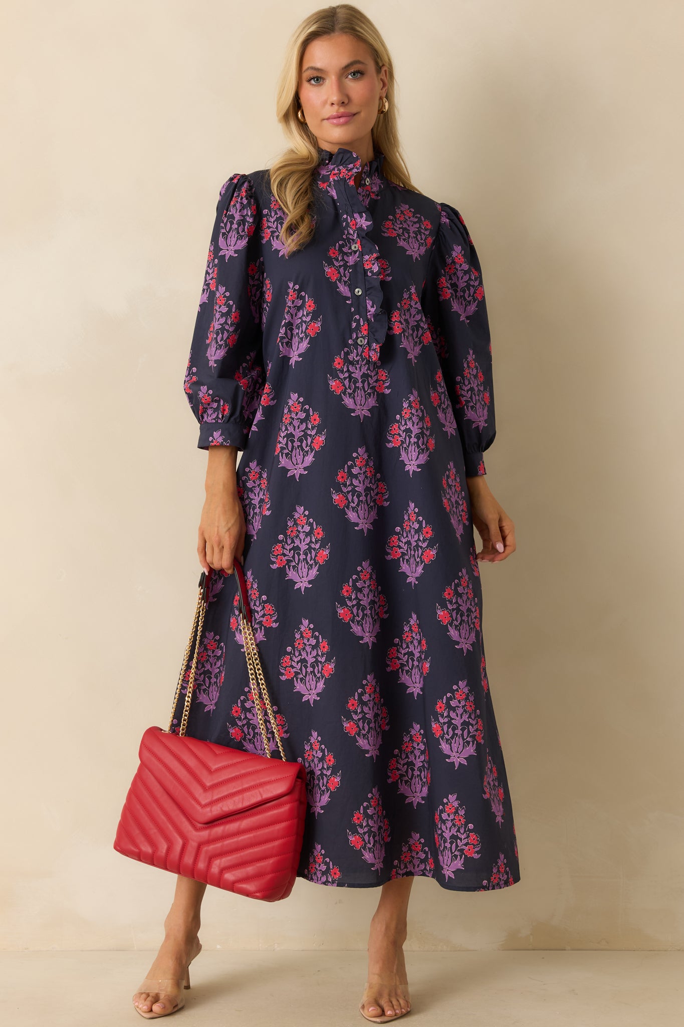 Navy floral dress displayed buttoned up, highlighting the subtle ruffle trim along the front placket.