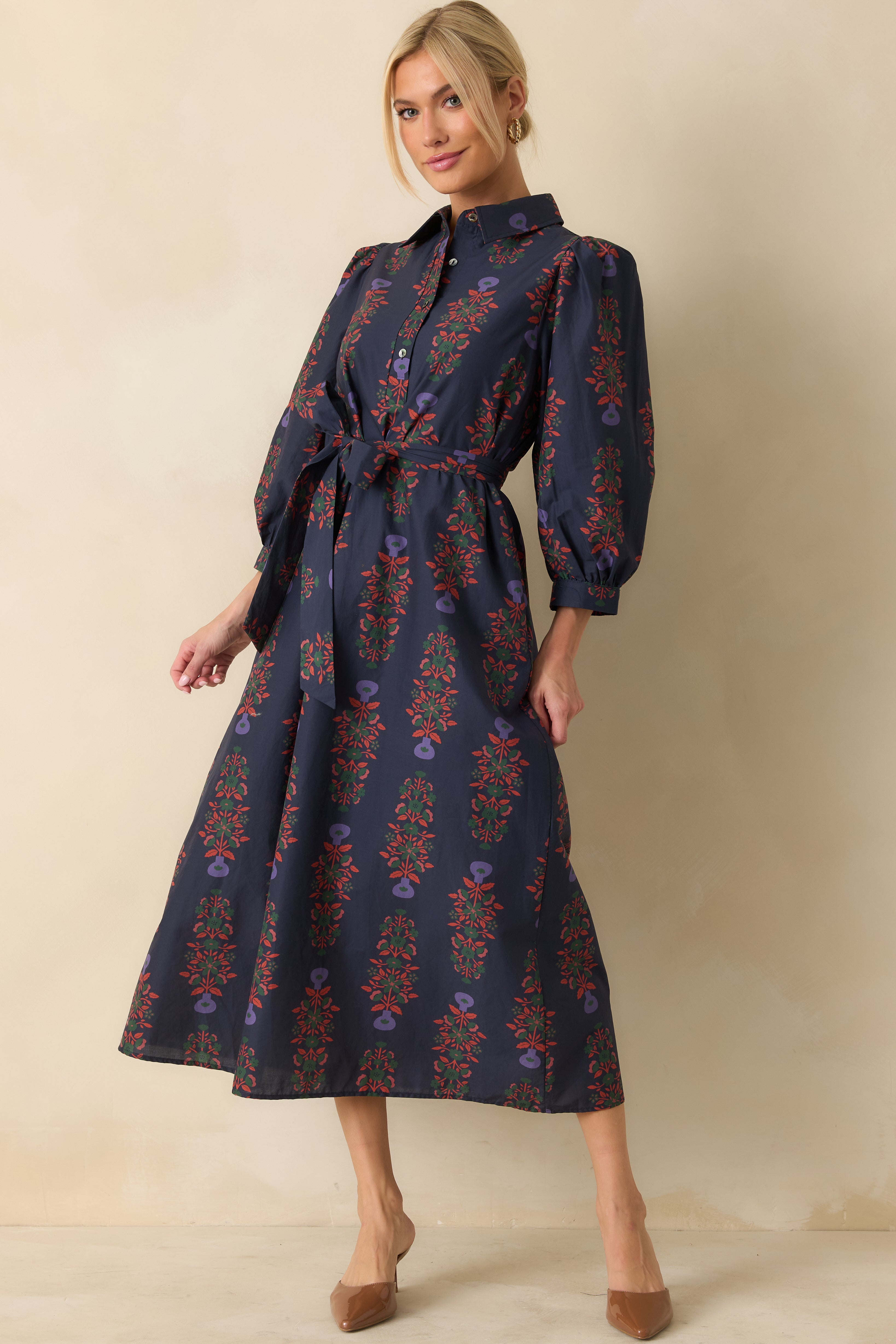 Front view of navy floral maxi dress with structured collar and flowing ankle-length skirt.