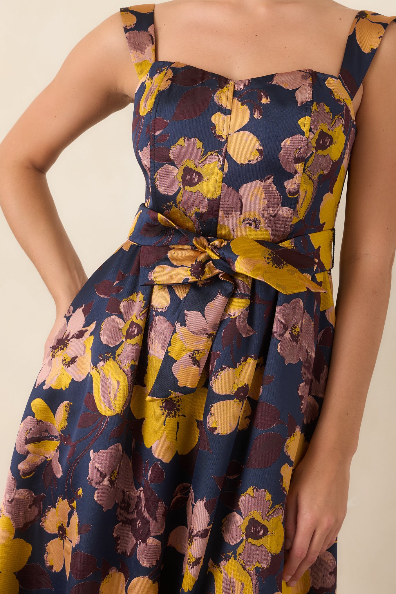 Close-up of the deep navy floral print, square neckline, and fitted bodice detailing.