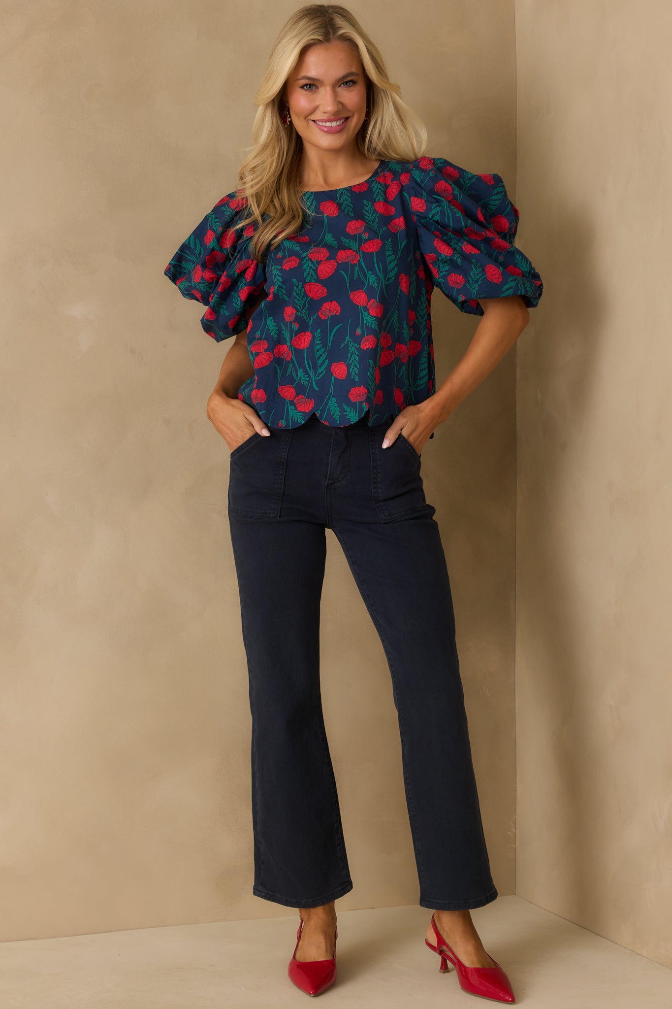 Navy floral top with red and green print, finished with a scallop hem.