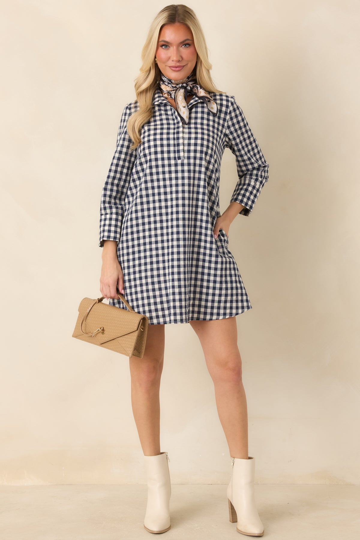 Classic gingham mini dress combines a tailored stand collar, concealed partial button placket, and softly flared skirt.