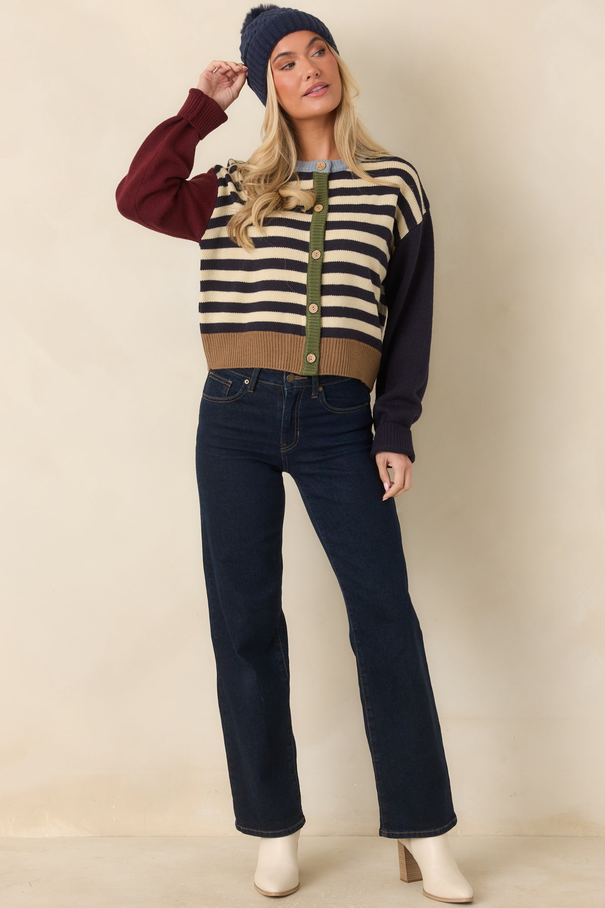 Navy and ivory striped cardigan with dropped shoulders, long sleeves, and ribbed cuffs in contrasting colors.