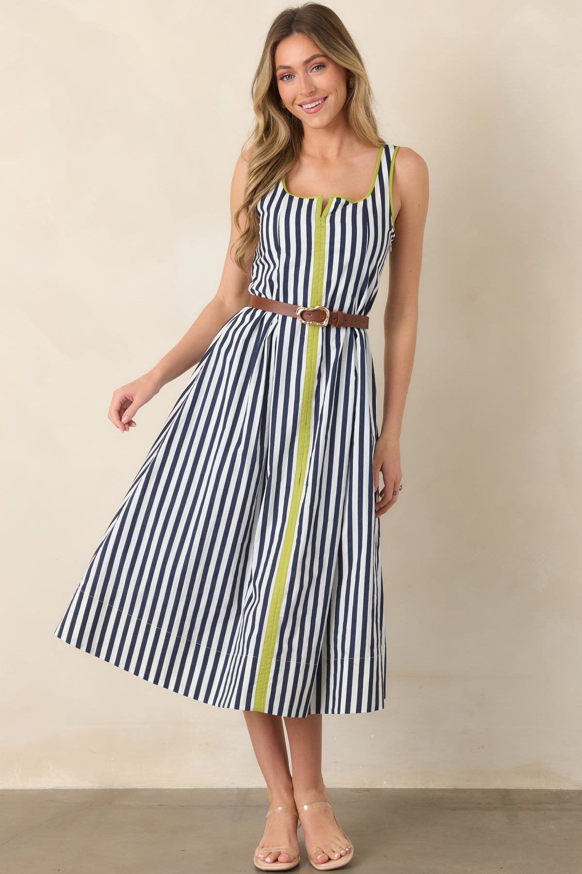 Navy and ivory striped dress highlighting its rounded square neckline, vivid chartreuse trim, functional pockets, and effortless midi-length skirt.