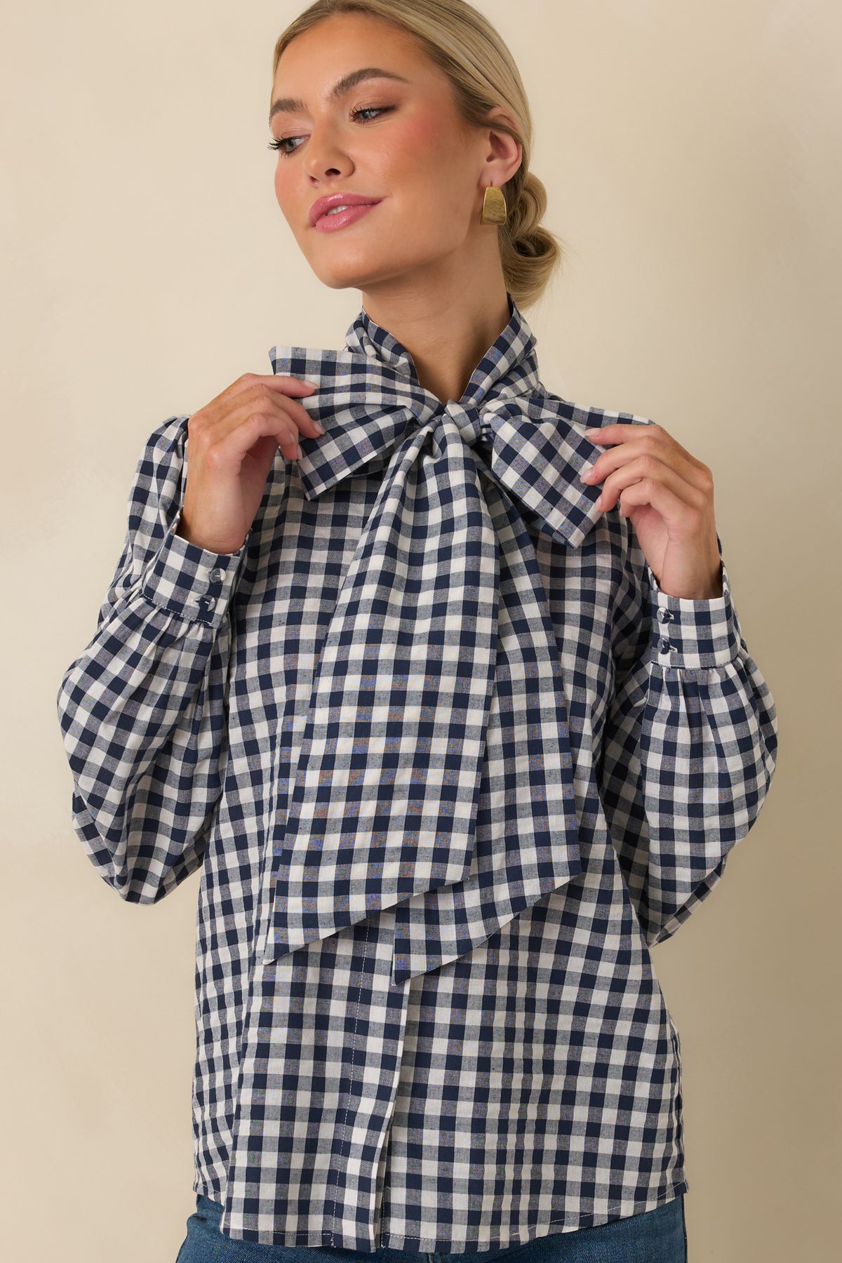 Relaxed gingham top with gathered long sleeves, buttoned cuffs, and a removable statement neck tie.