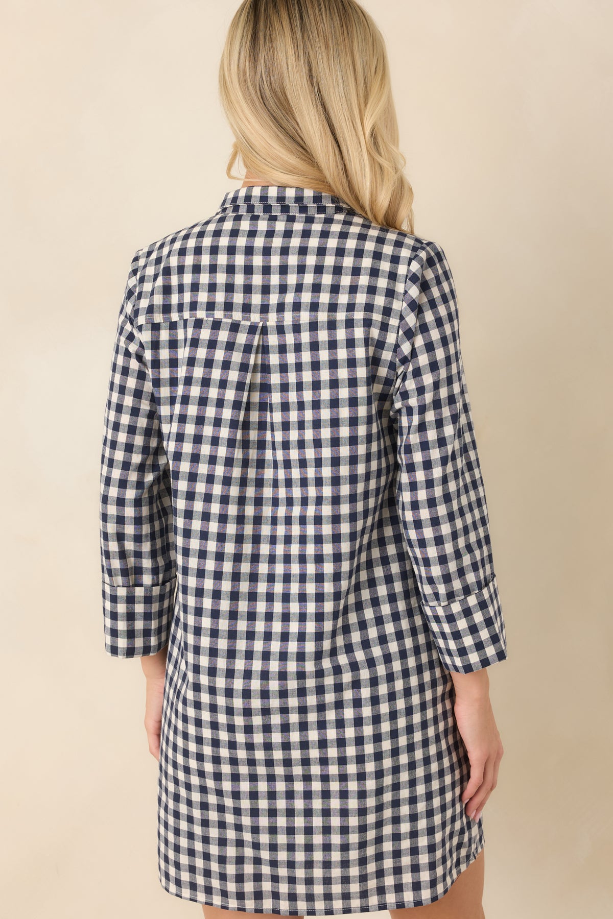 Rear of the navy and ivory gingham mini dress showcases the structured collar, three-quarter sleeves, and relaxed A-line shape.