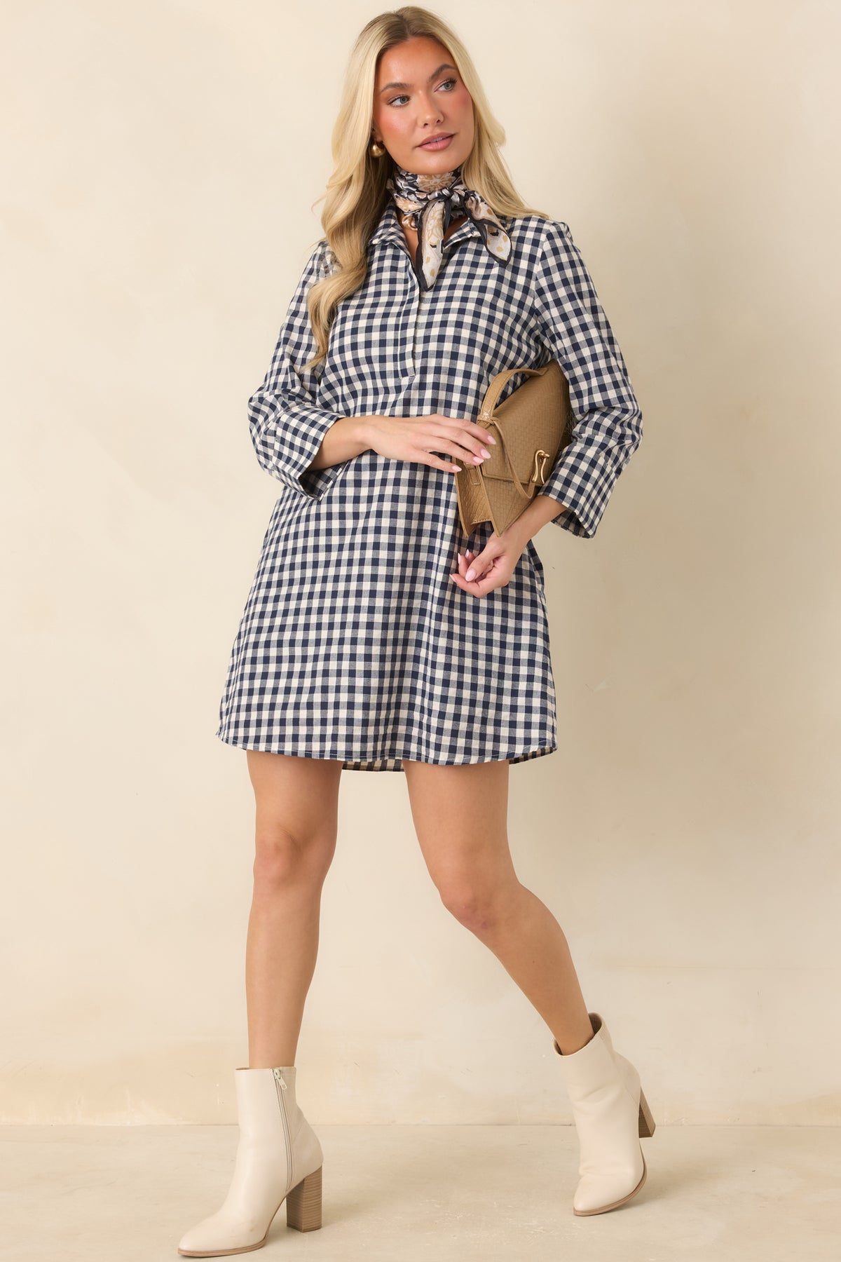 Navy and ivory gingham mini dress features a structured stand collar, three-quarter sleeves, and a relaxed A-line silhouette.