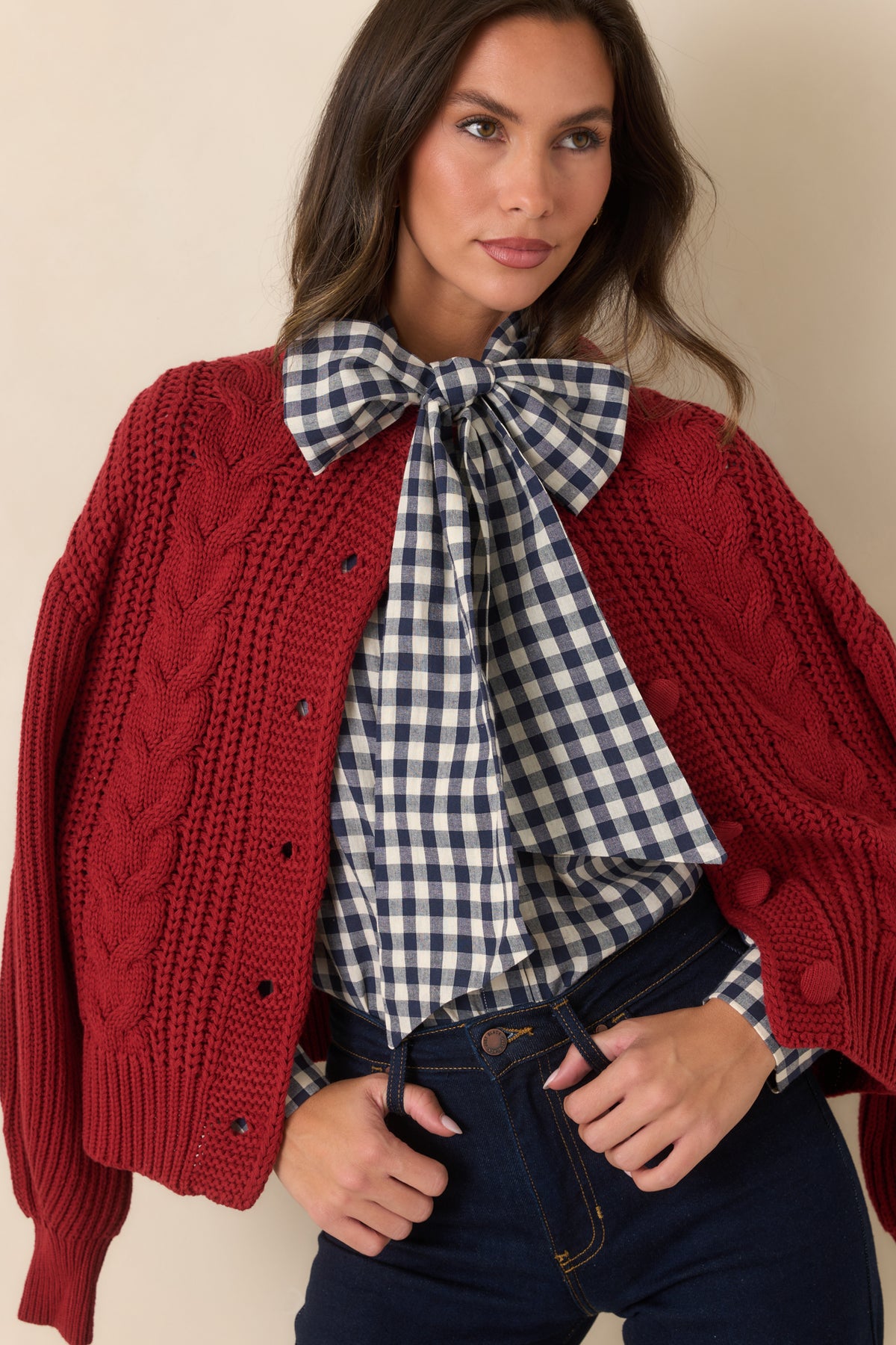 Navy and ivory gingham pattern paired with a relaxed silhouette and oversized statement bow.
