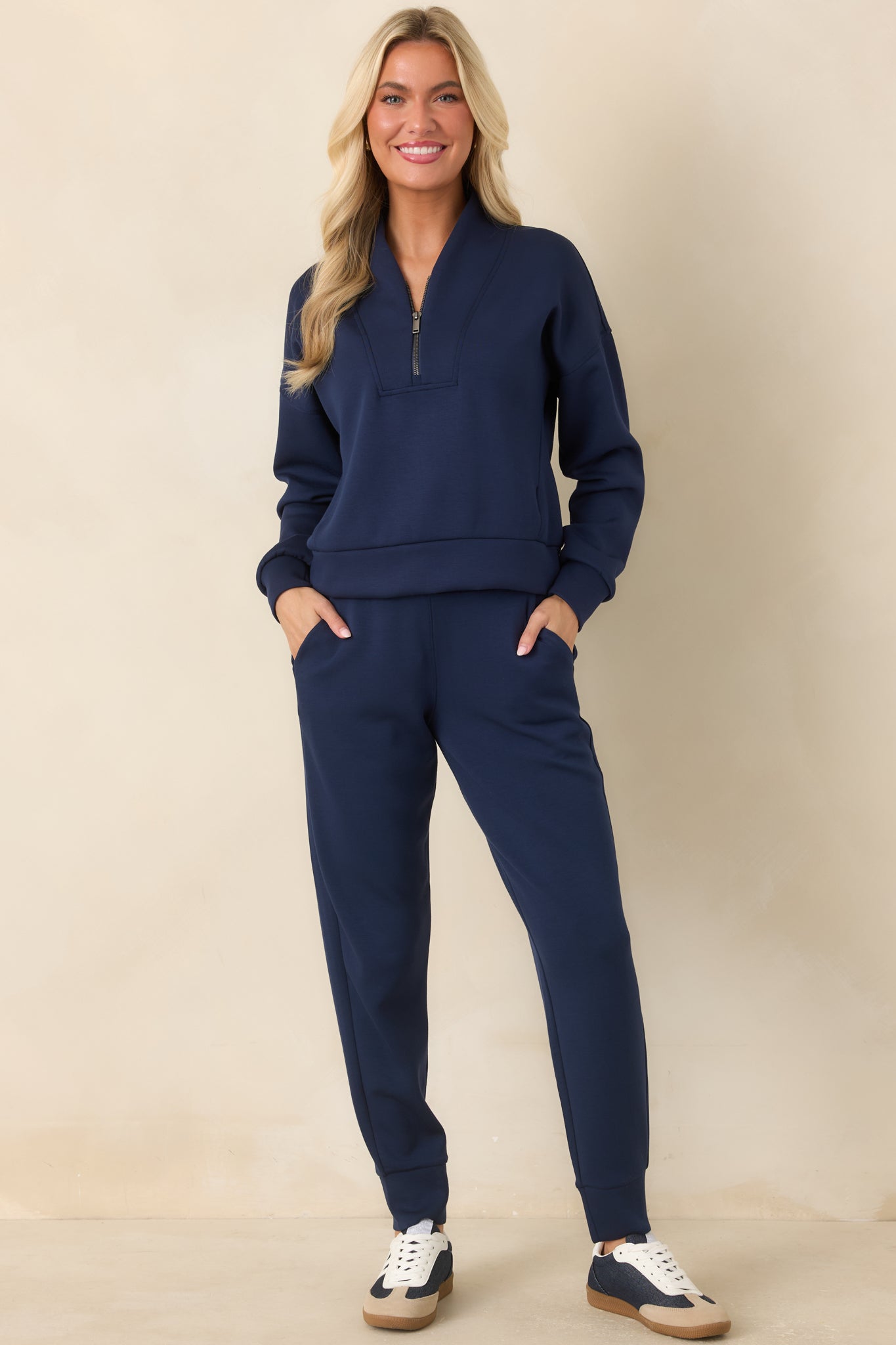 Navy lightweight spacer fabric joggers featuring a pull-on waistband, adjustable drawstring, relaxed legs, and tapered cuffs.