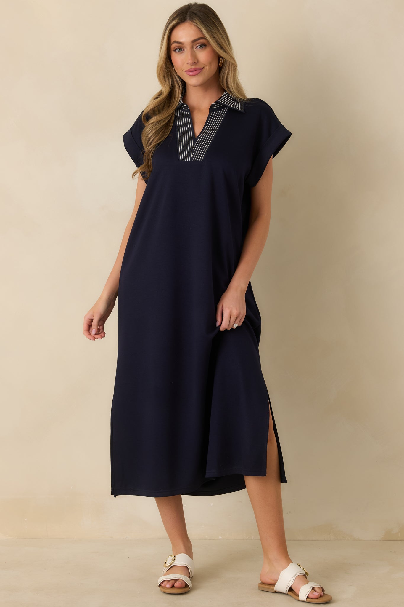 Navy knit midi dress with a minimalist silhouette, short sleeves, and an effortless everyday shape.