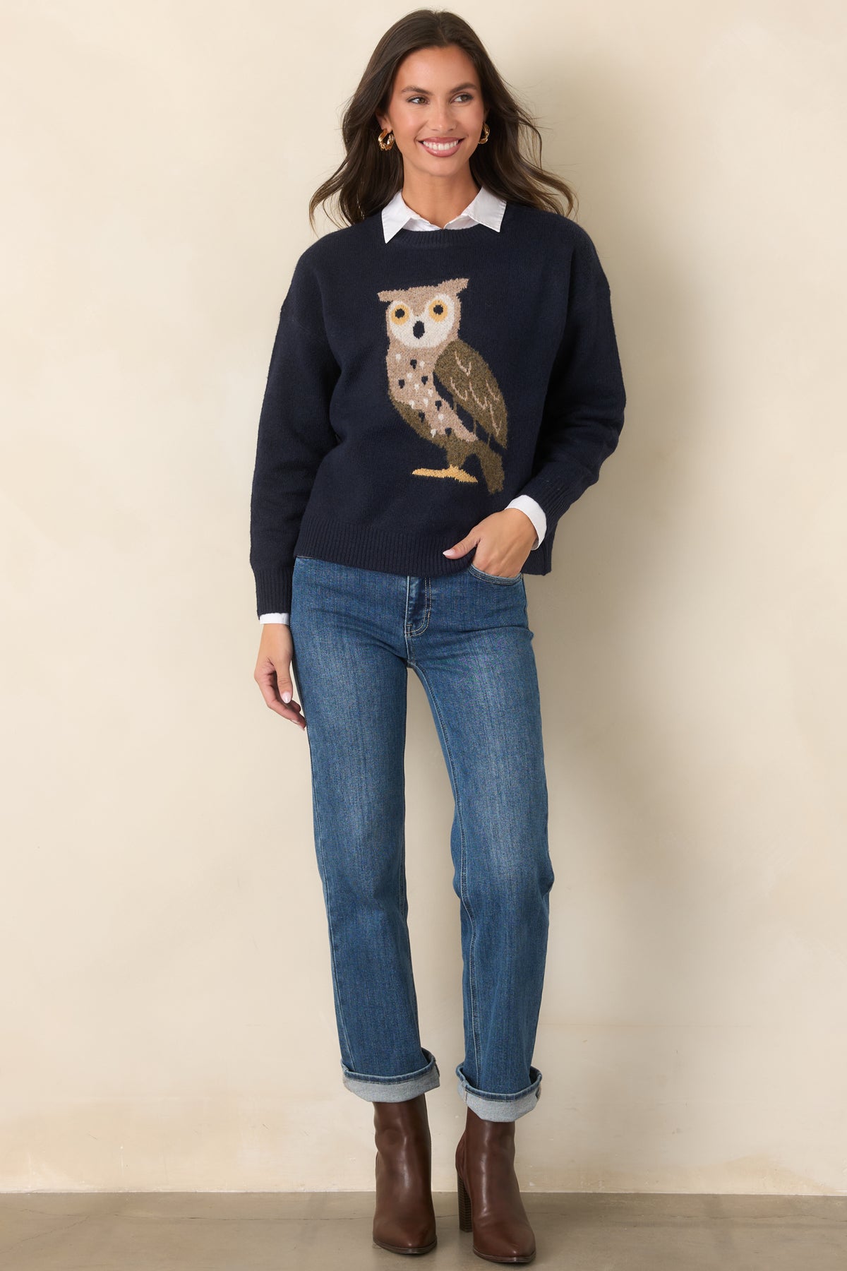 Long-sleeve navy pullover showcasing an oversized owl motif in earthy tones with ribbed cuffs and a matching hem.