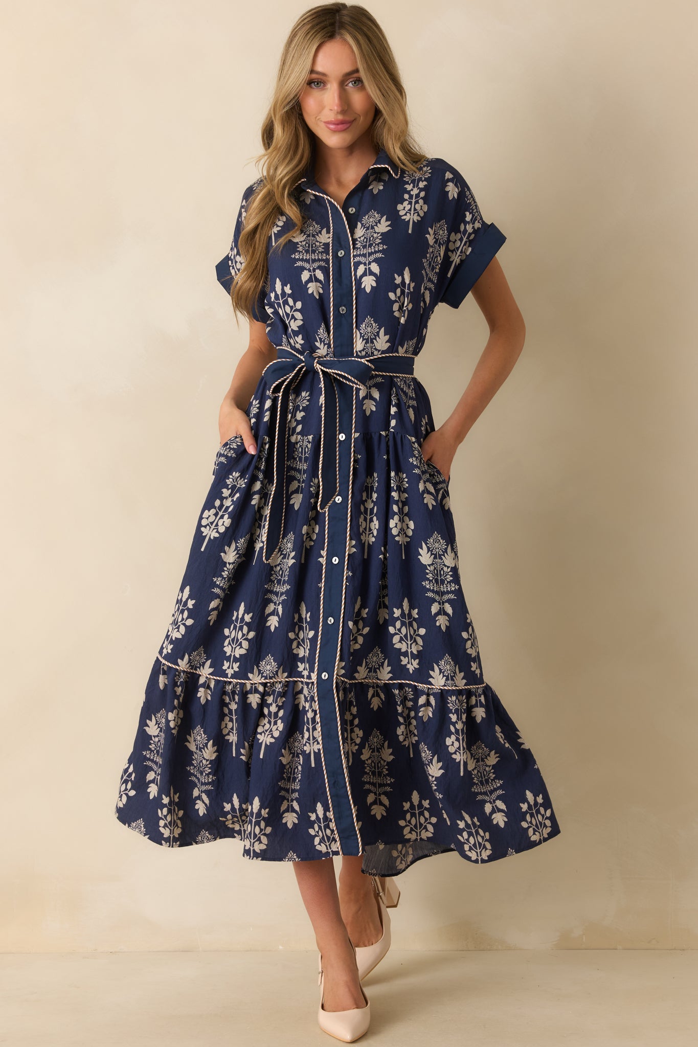 Tiered navy maxi dress with stripe contrast piping on the placket, short sleeves, and subtle ivory florals.