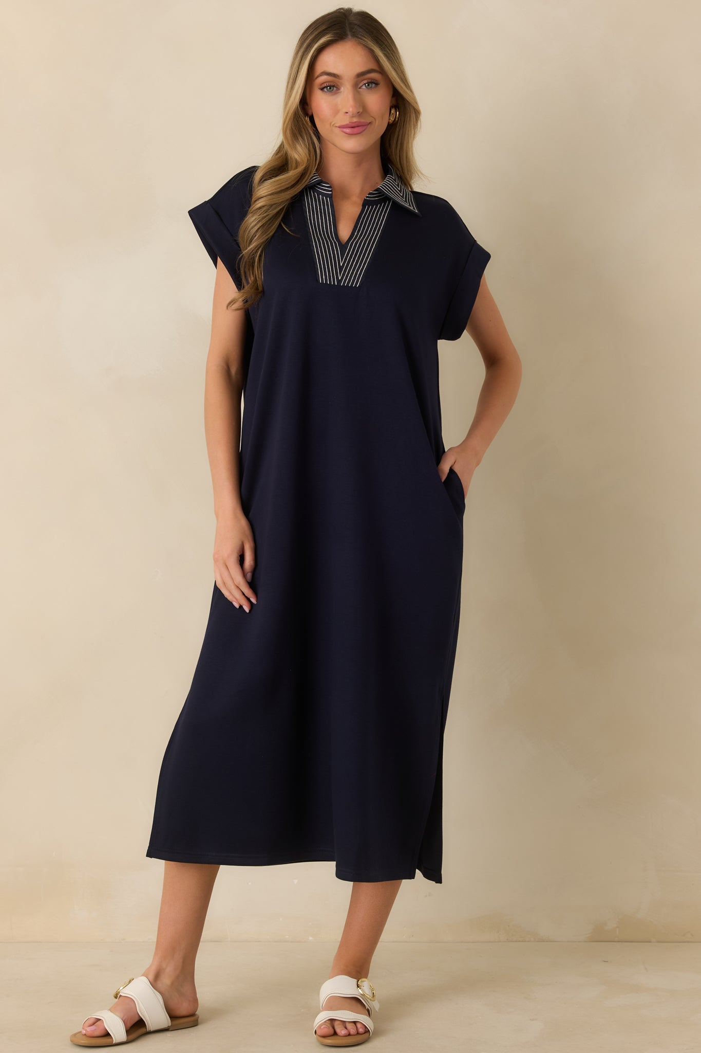 Navy knit midi dress with a relaxed straight silhouette, V-neckline, and contrast stitch detailing for subtle visual interest.