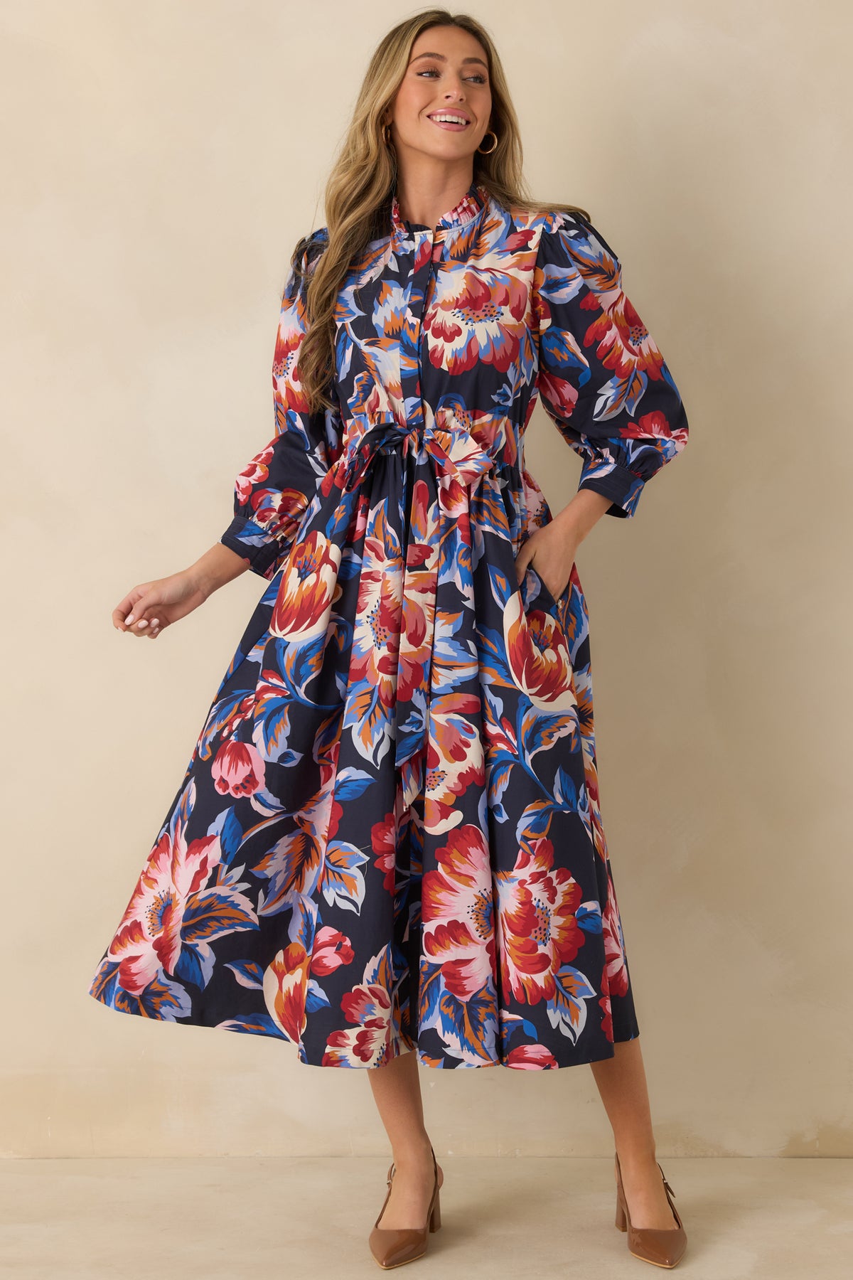 100% cotton midi dress featuring red, pink, orange, ivory, and blue florals with a defined tie waist.