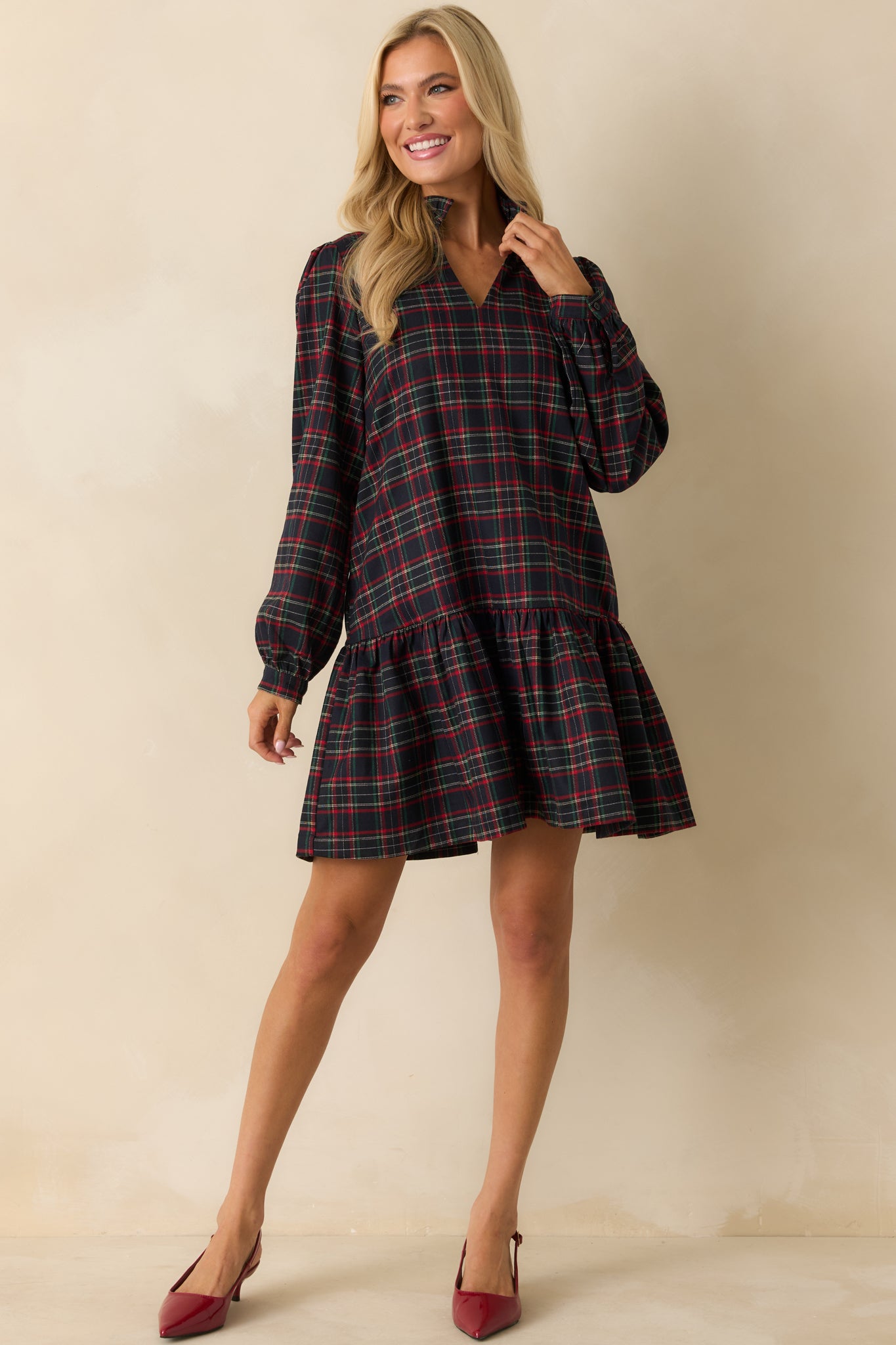 Navy multi plaid mini dress in soft woven flannel with split neckline, standing collar, long sleeves, and tiered ruffle hem.