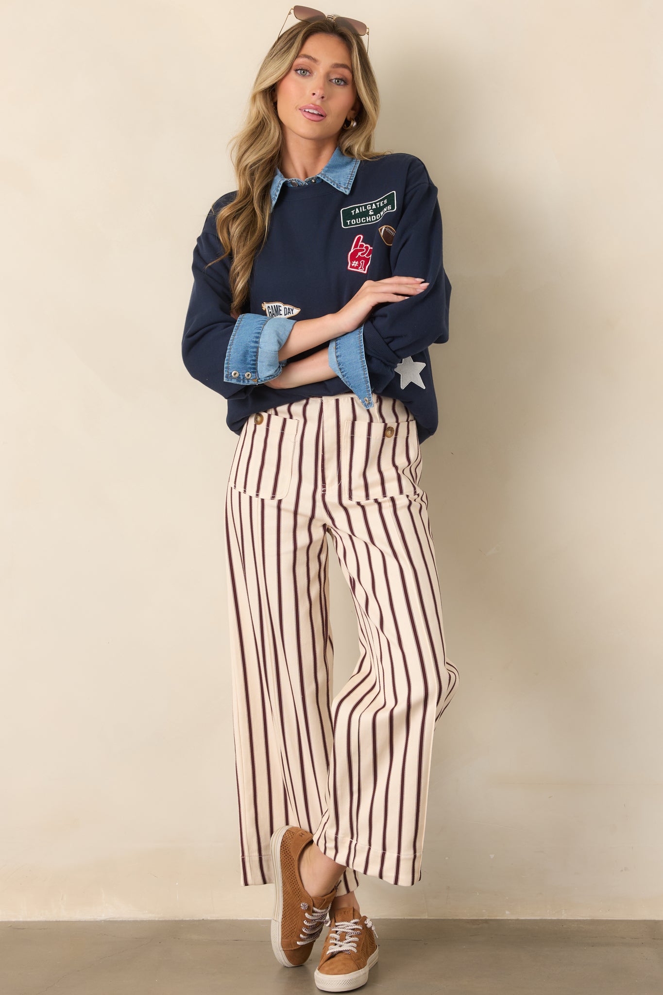 Navy boyfriend-fit sweatshirt with a relaxed silhouette, crew neckline, dropped shoulders, long sleeves, ribbed trim, and decorative sports patches.