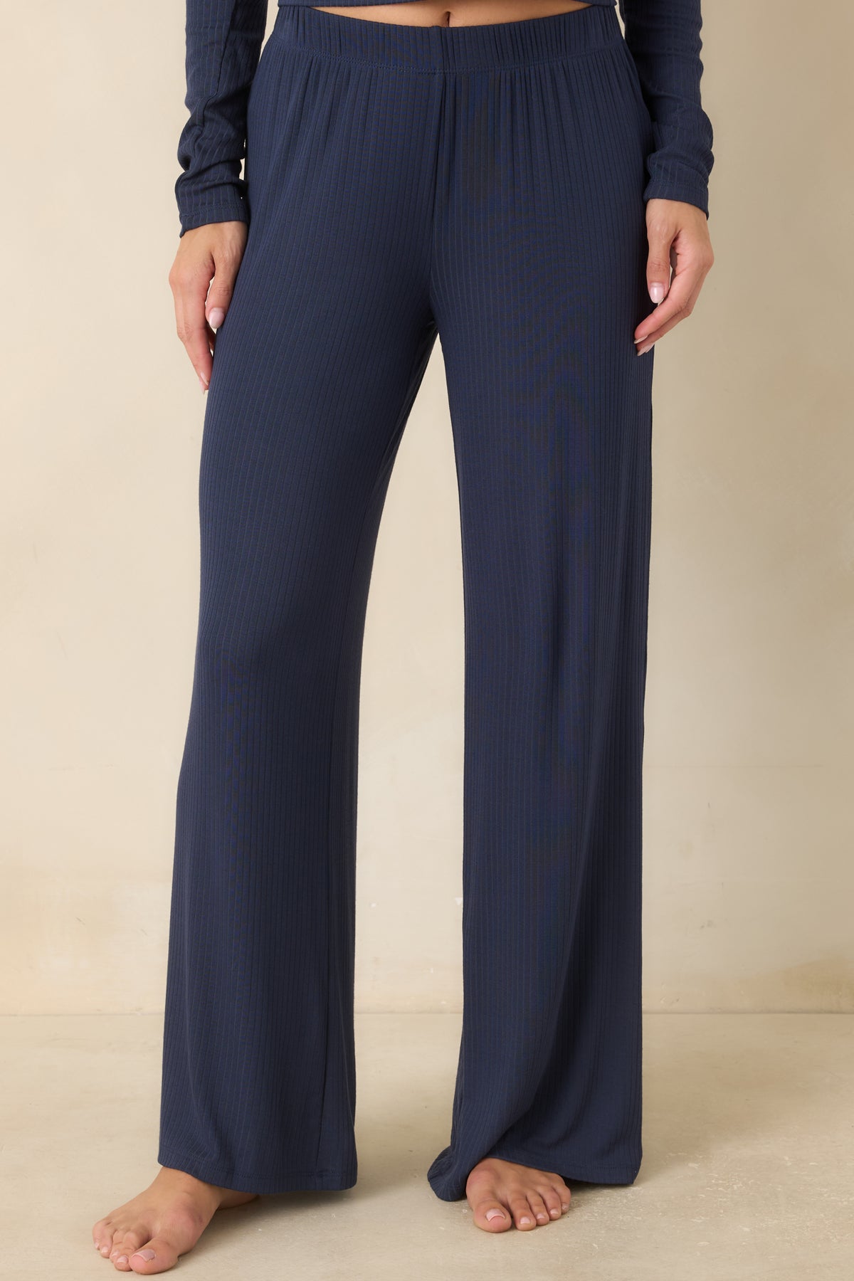 Detailed view of the navy ribbed fabric highlighting the soft texture and relaxed construction of the wide leg pants.