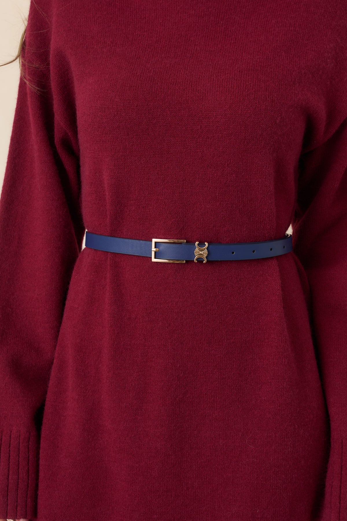 Navy slim belt crafted from smooth faux leather with a sleek gold-tone buckle.