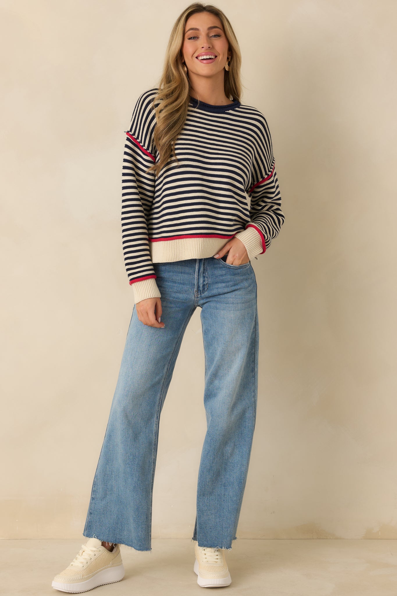 Navy stripe sweater featuring a classic crew neckline, soft cotton-blend knit, and lightweight drape ideal for layering.