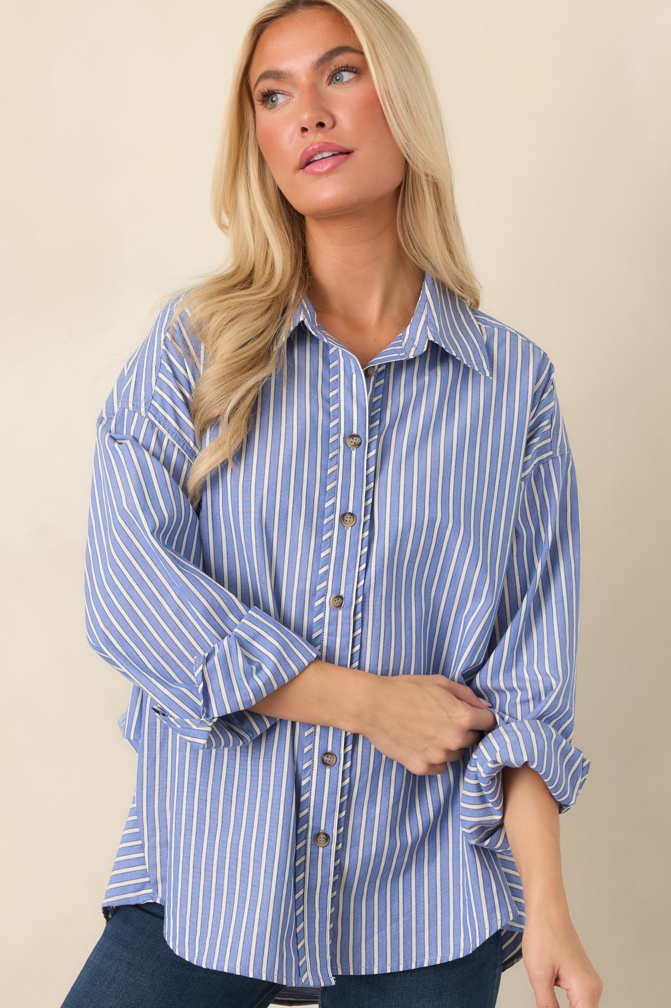 Detailed view of the navy shirt showcasing the ivory stripes, smooth front placket, and polished button accents.