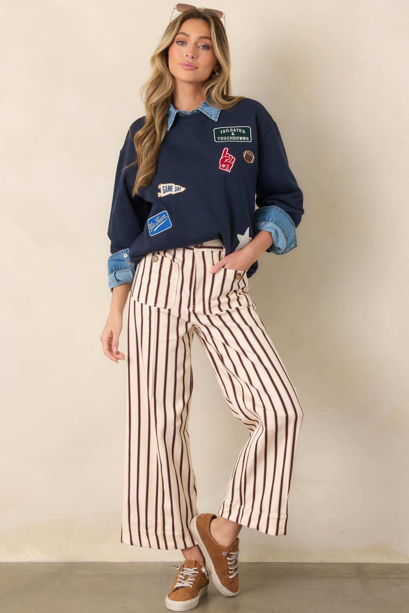 Relaxed navy sweatshirt featuring a classic crew neck, oversized dropped shoulders, ribbed cuffs and hem, and football-inspired embroidered details.