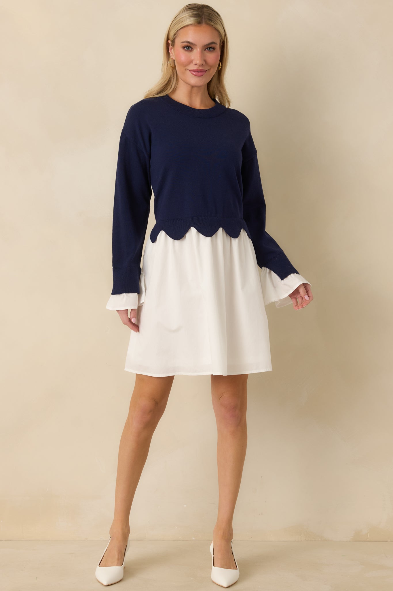 Navy and white mini dress featuring a soft knit sweater bodice, round neckline, and relaxed silhouette with balanced contrast.