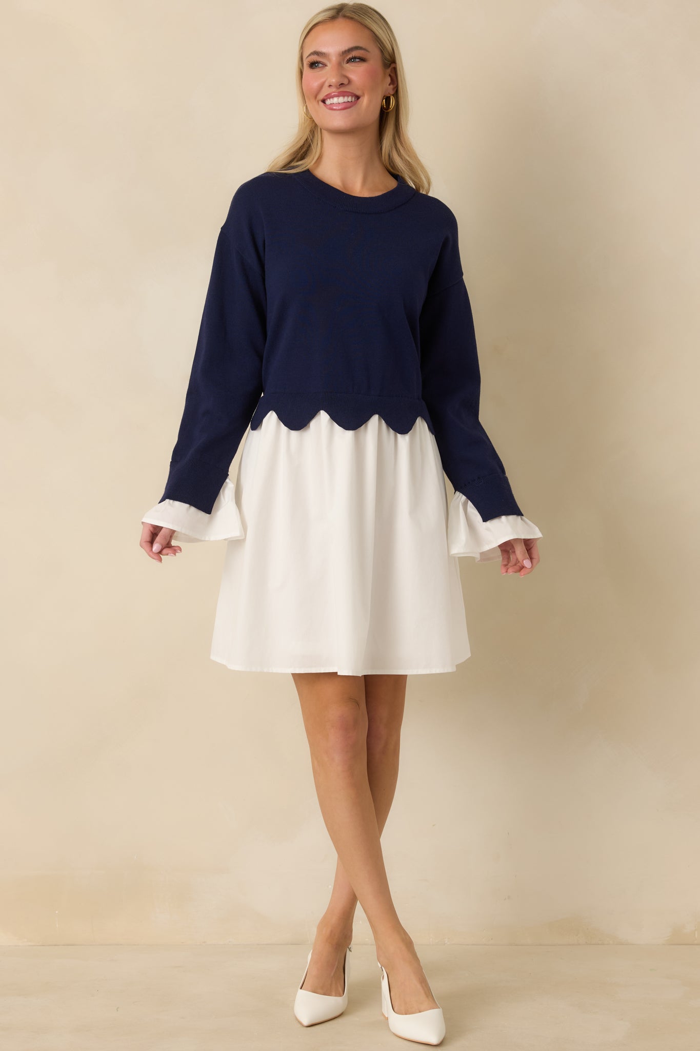 Navy and white mini dress highlighting the contrast between the structured knit bodice and airy woven skirt.