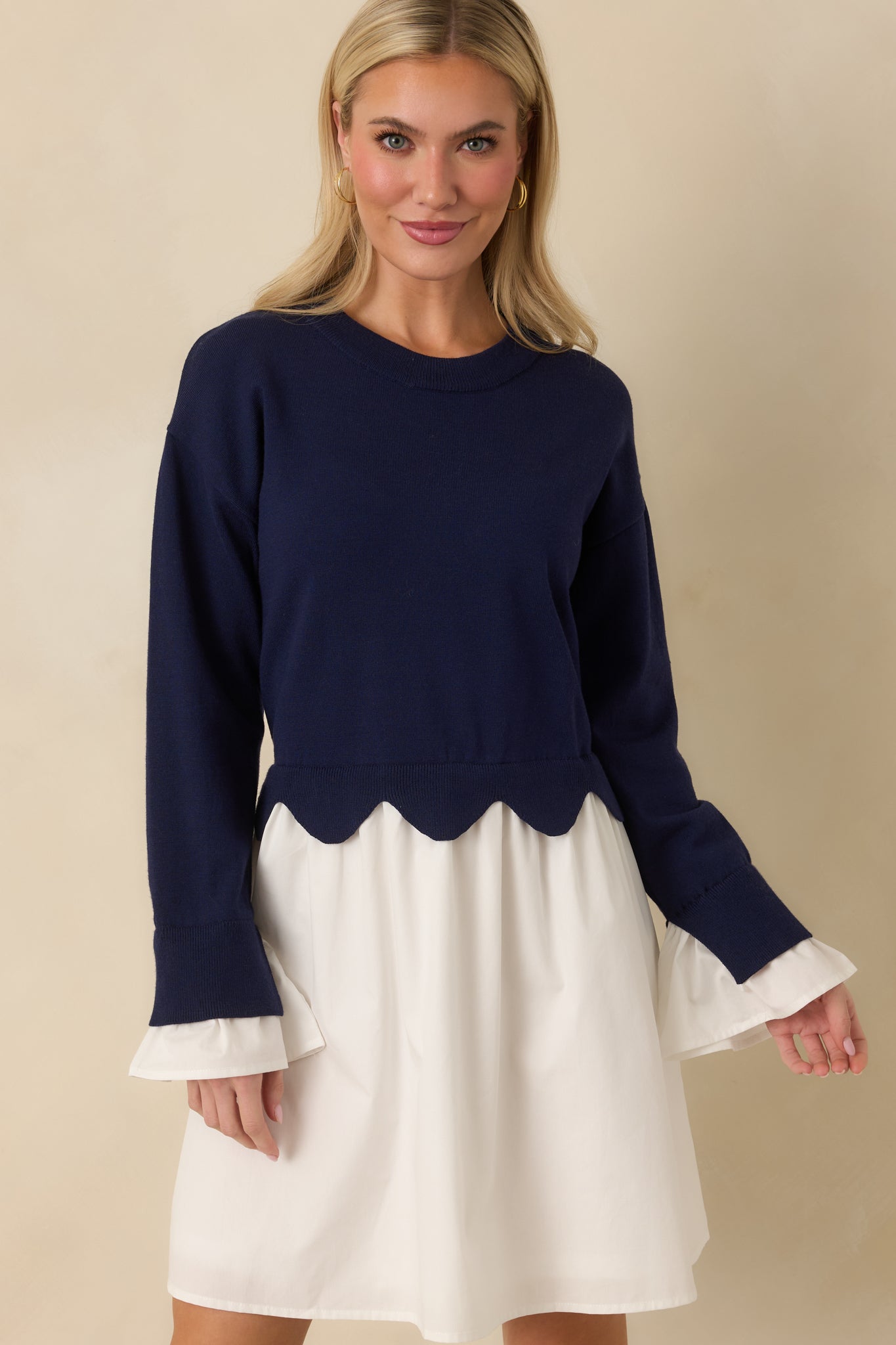 Navy and white mini dress showcasing the long sleeves and soft knit texture.