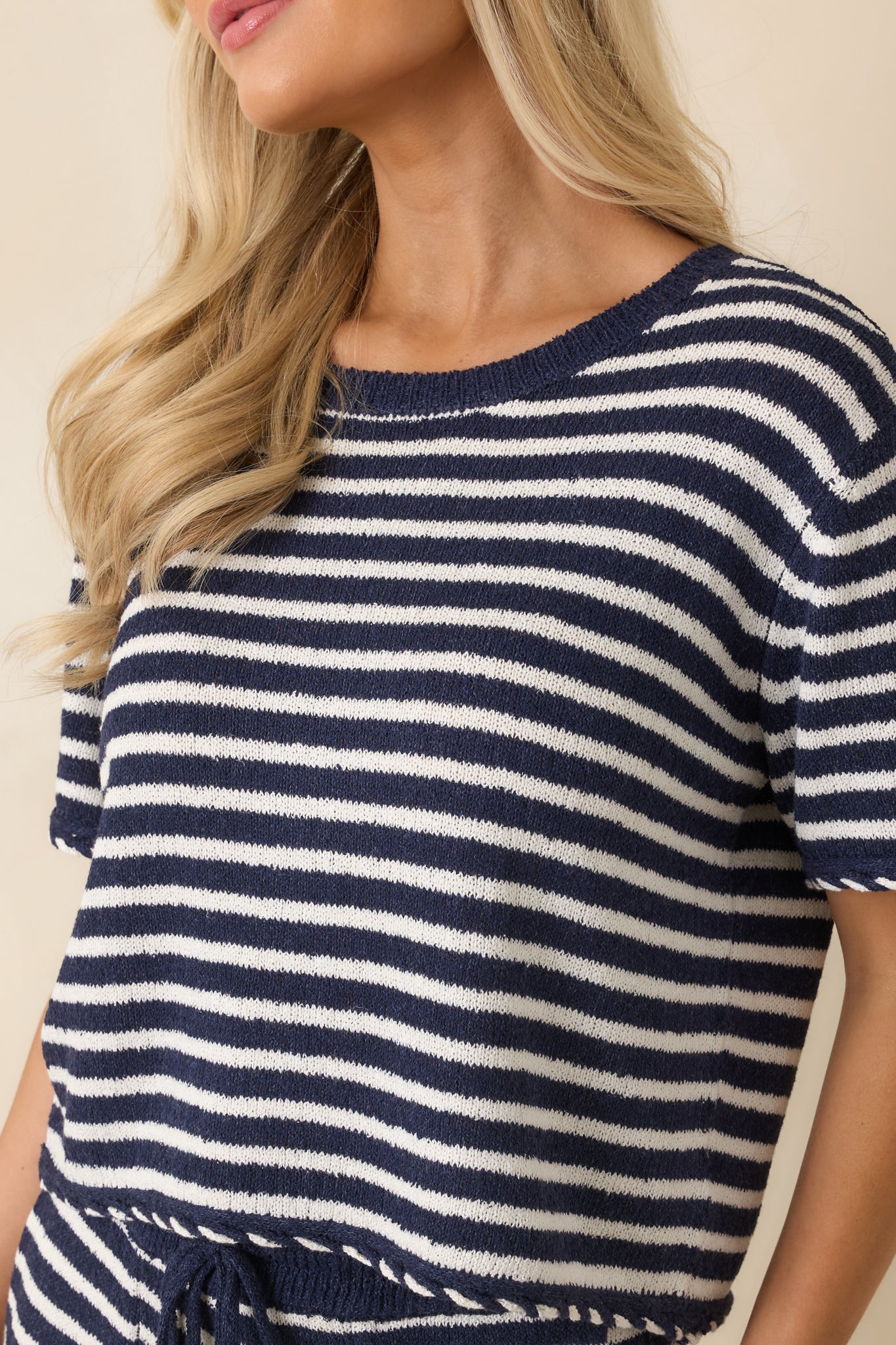 Detailed view of the navy blue and white striped fabric highlighting the soft french terry texture and oversized whipstitch trim.